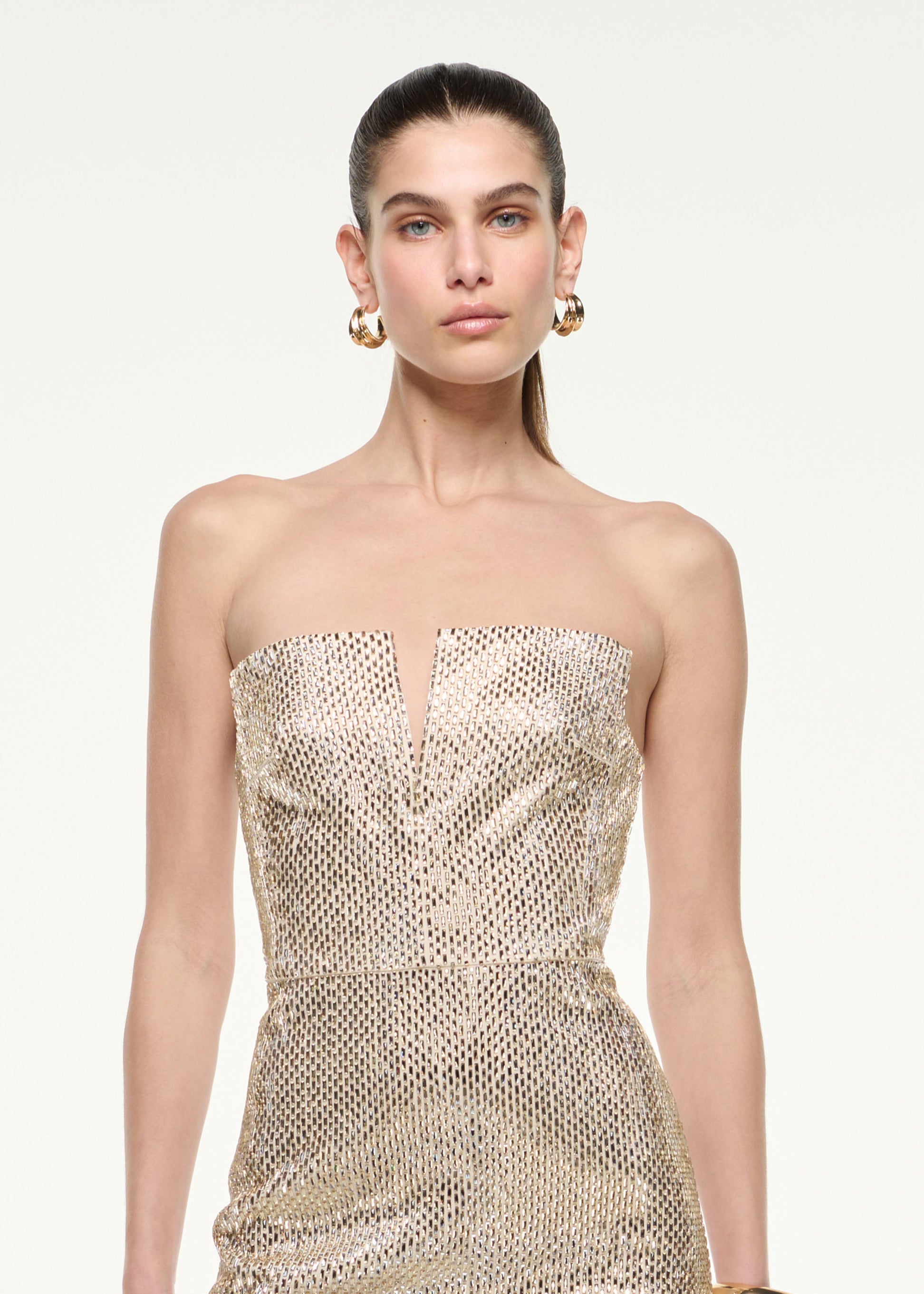 Close up of a model wearing the Cut Out Diamante Mini Dress in Champagne
