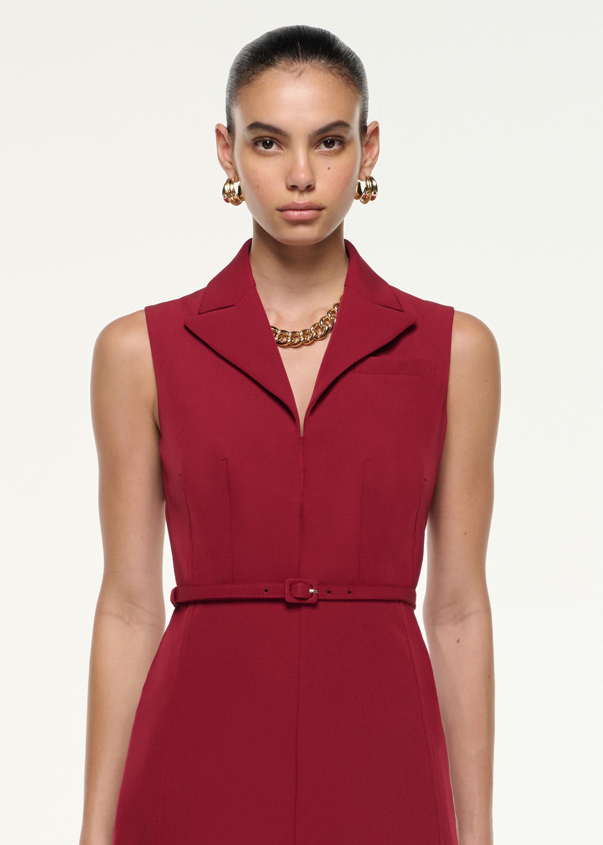 Close up of a model wearing the Belted Collar Midi Dress in Dark Red