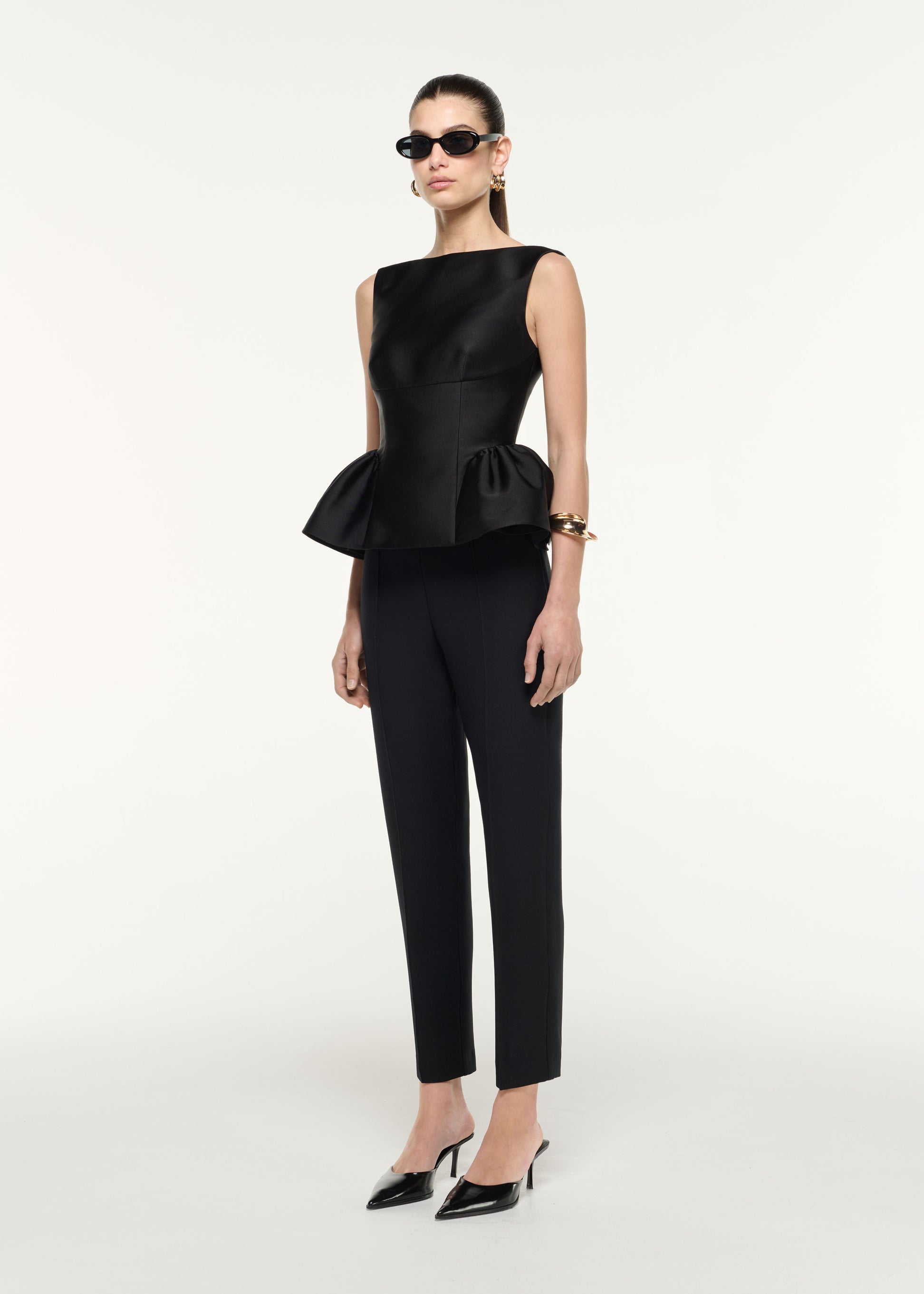 Side view of a model wearing the Wool Silk Cropped Trouser in Black