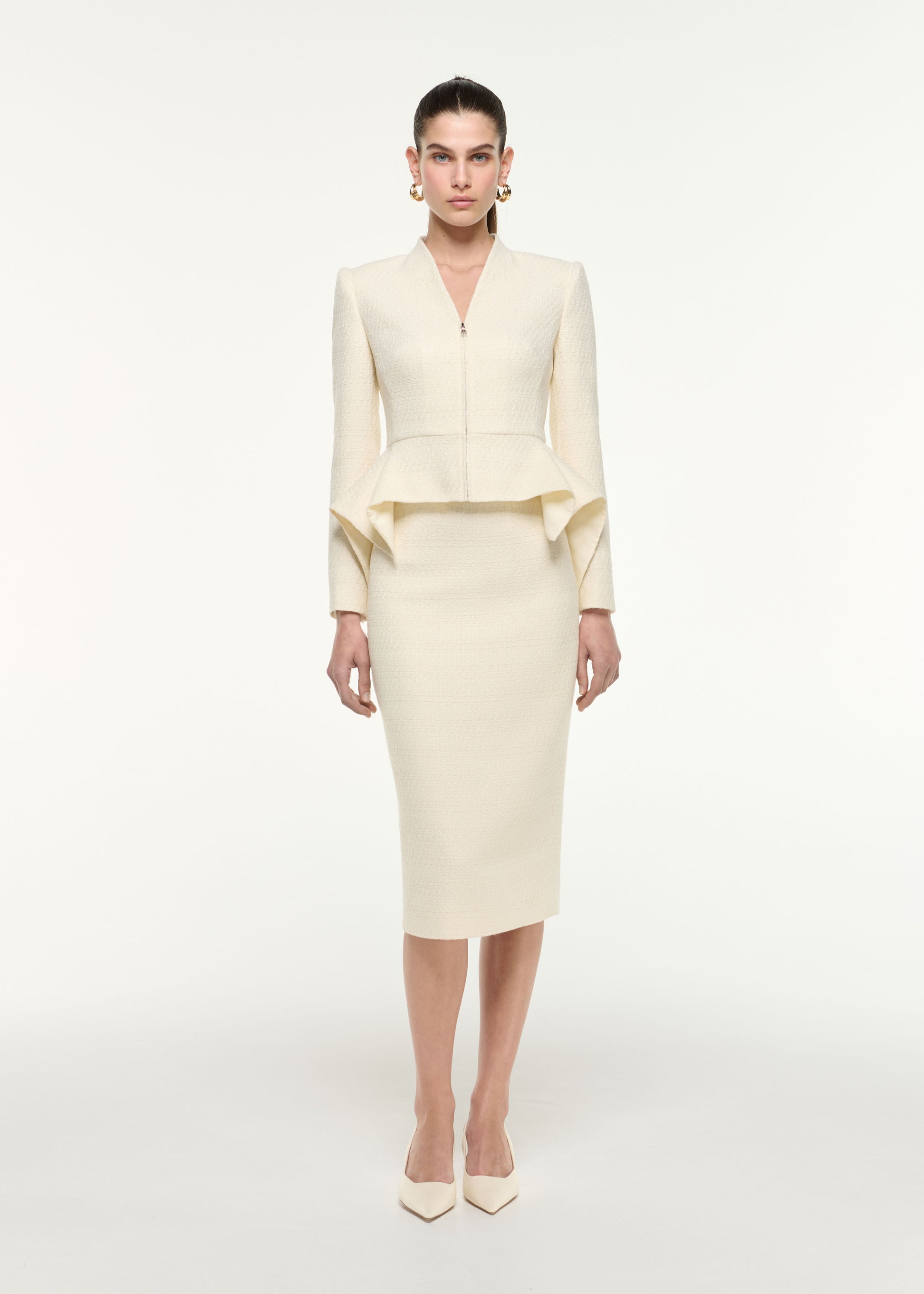 Front view of a model wearing the Boucle Midi Skirt in Cream