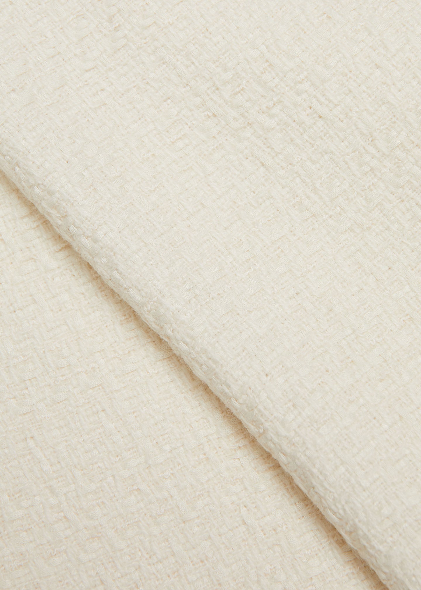 Close up of a model wearing the Boucle Midi Skirt in Cream