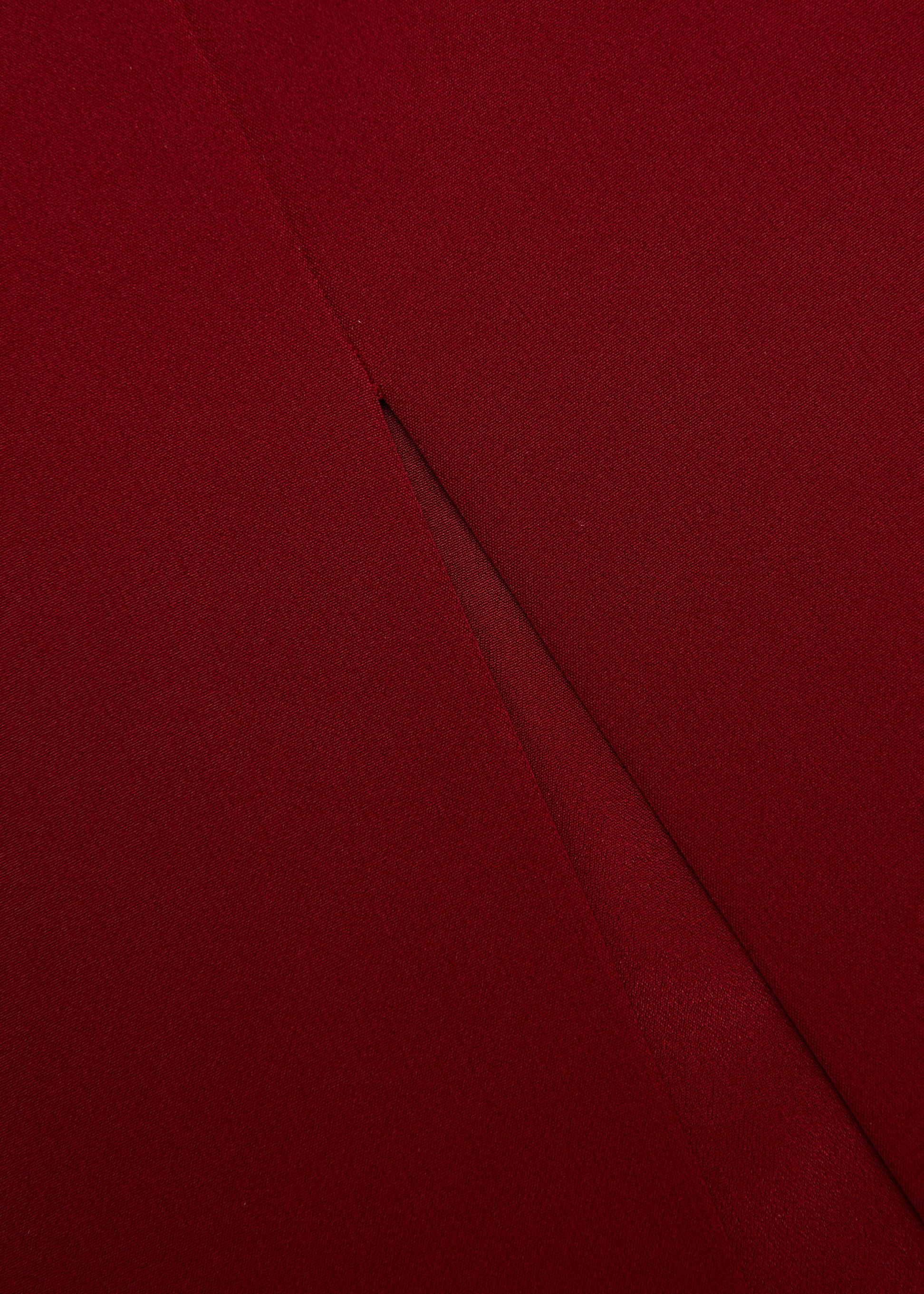 Close up of a model wearing the Light Crepe Midi Skirt in Dark Red