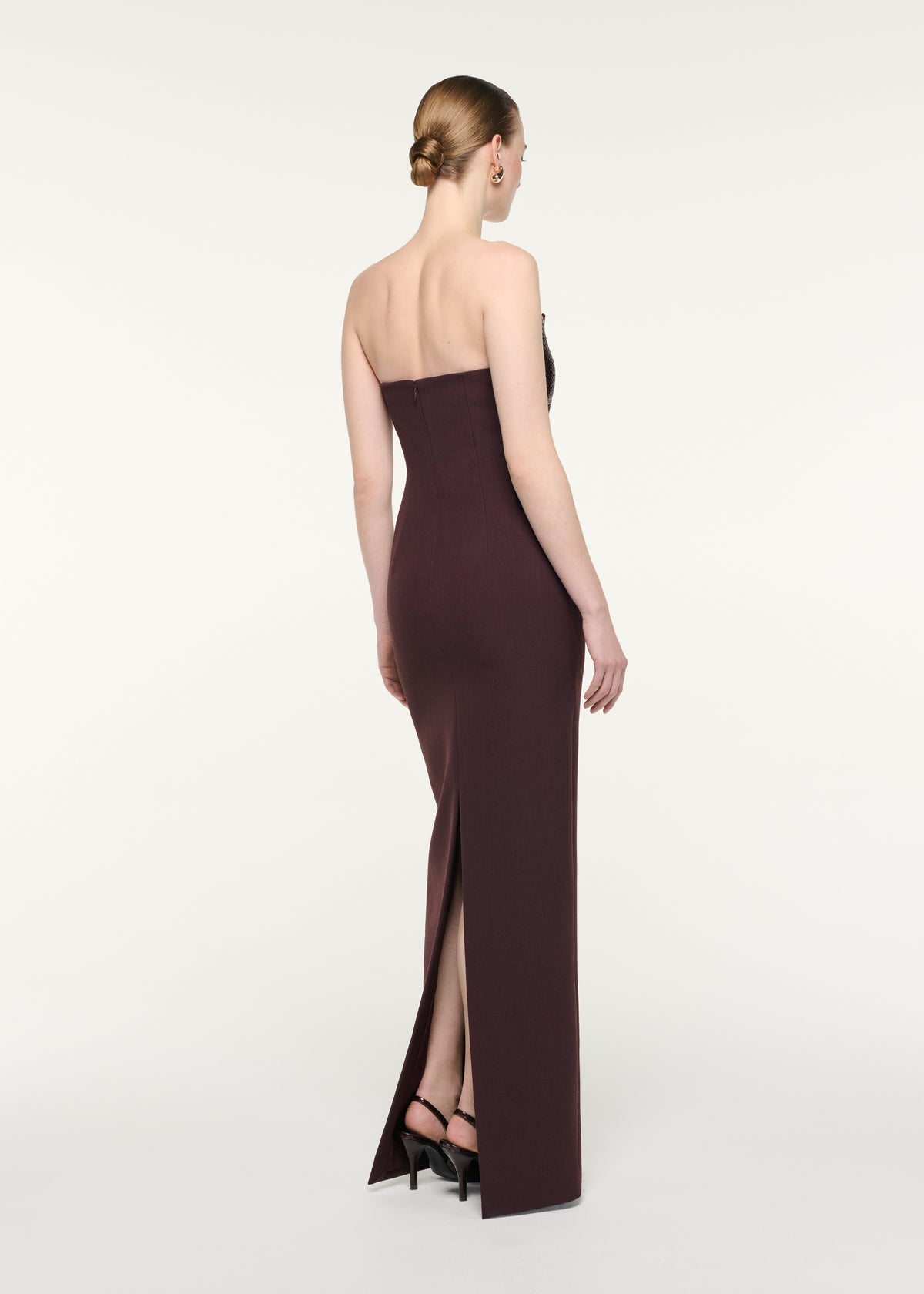 Back view of a model wearing the Strapless Diamate Panel Gown