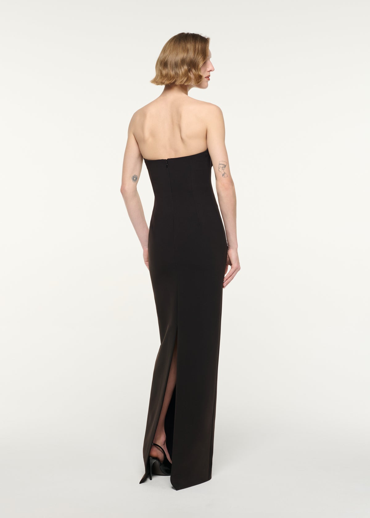 Back view of a model wearing the Strapless Monochrome Drape Gown
