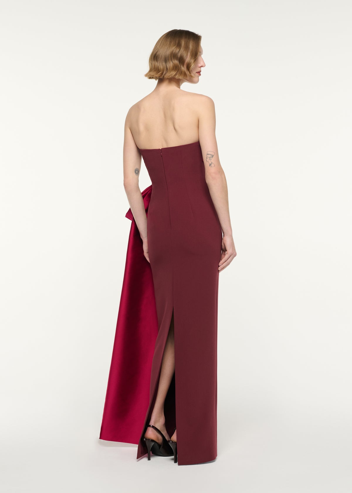 Back view of a model wearing the Contrast Drape Strapless Gown