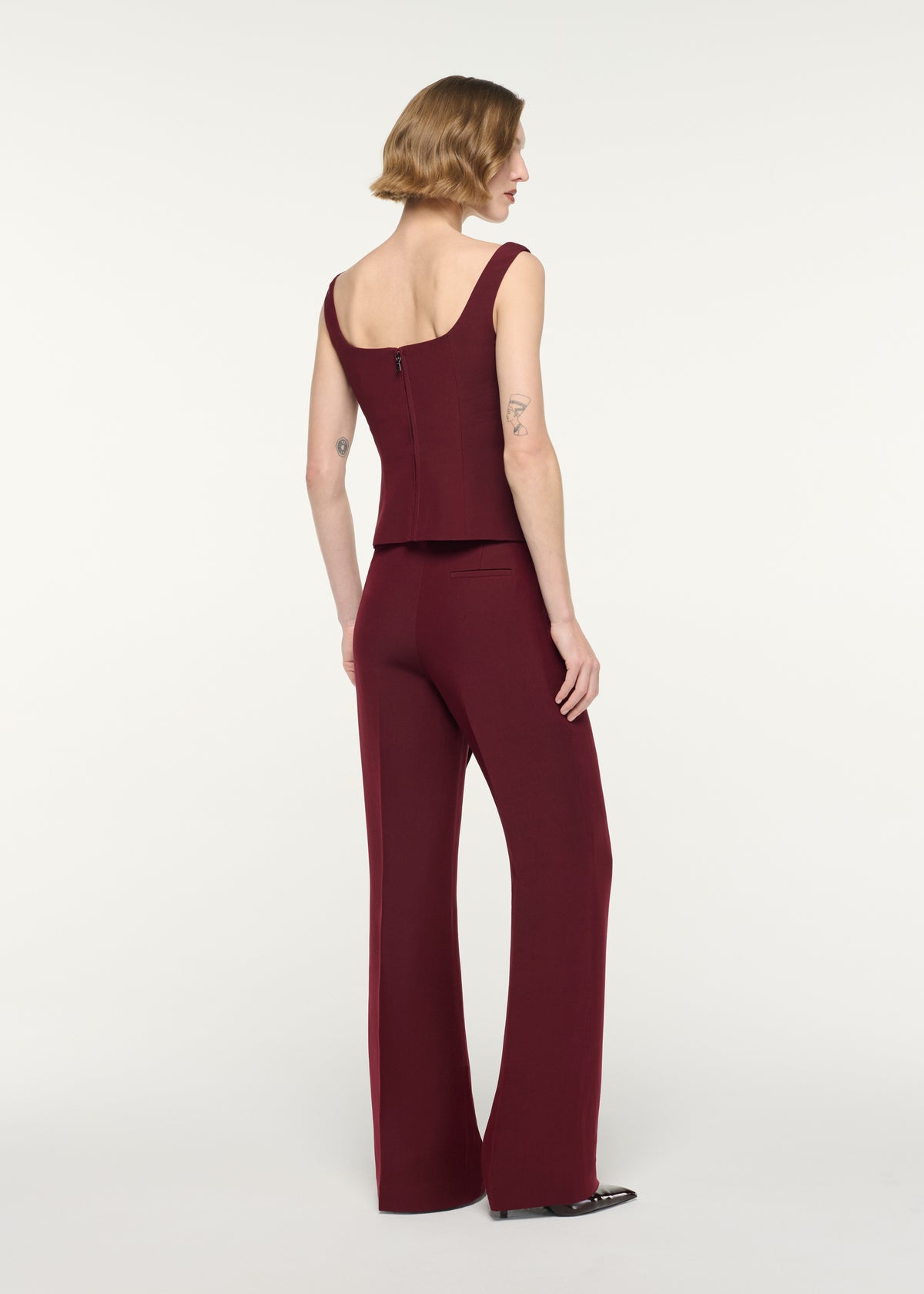 Back view of a model wearing the Wide Strap Fitted Drape Top