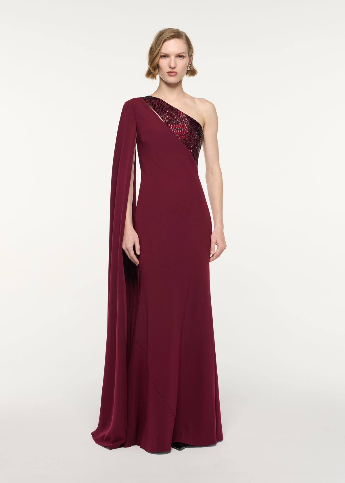 Front view of a model wearing the Diamante Panel One Shoulder Cape Gown