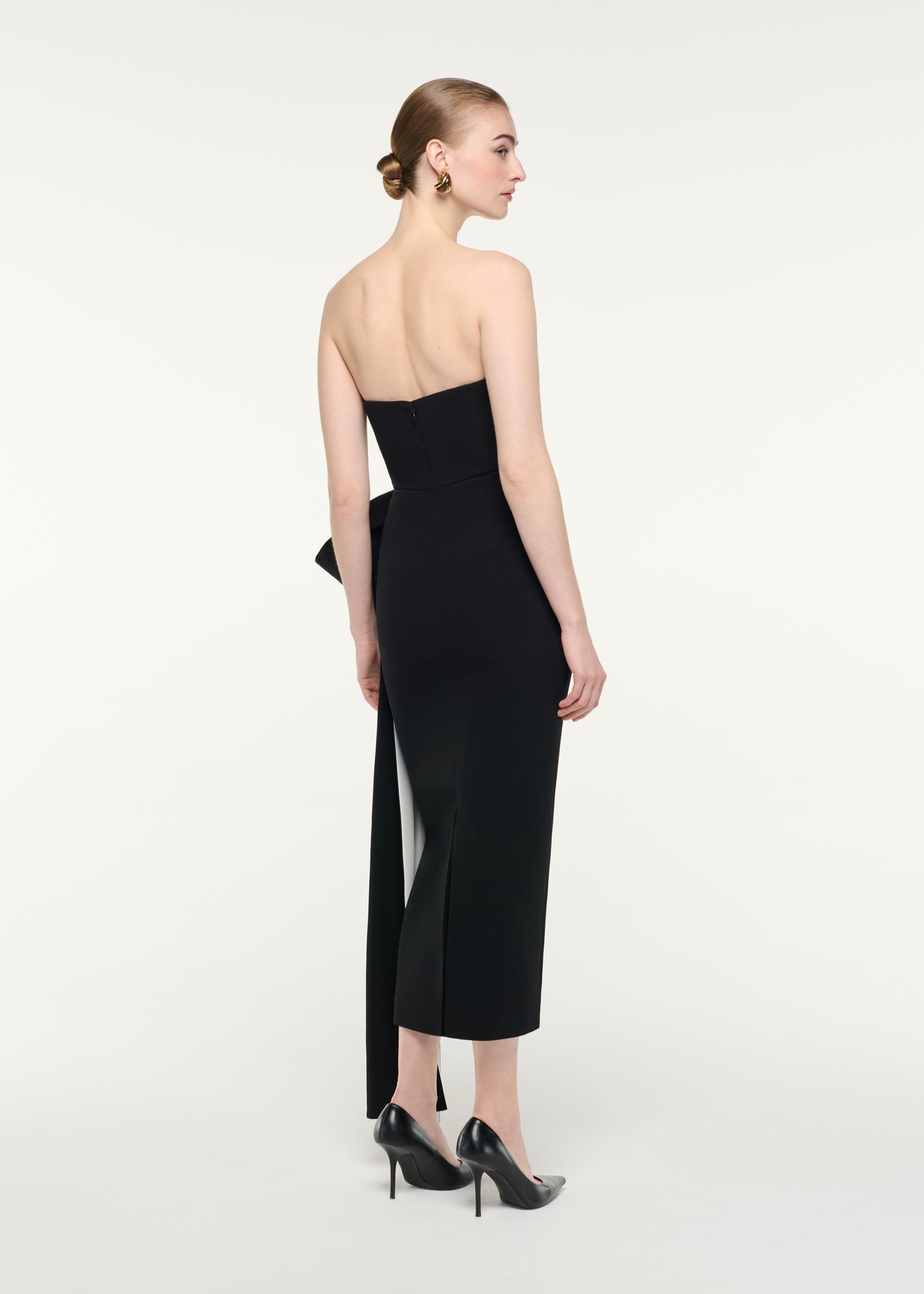 Back view of a model wearing the Monochrome Draped Midi Dress
