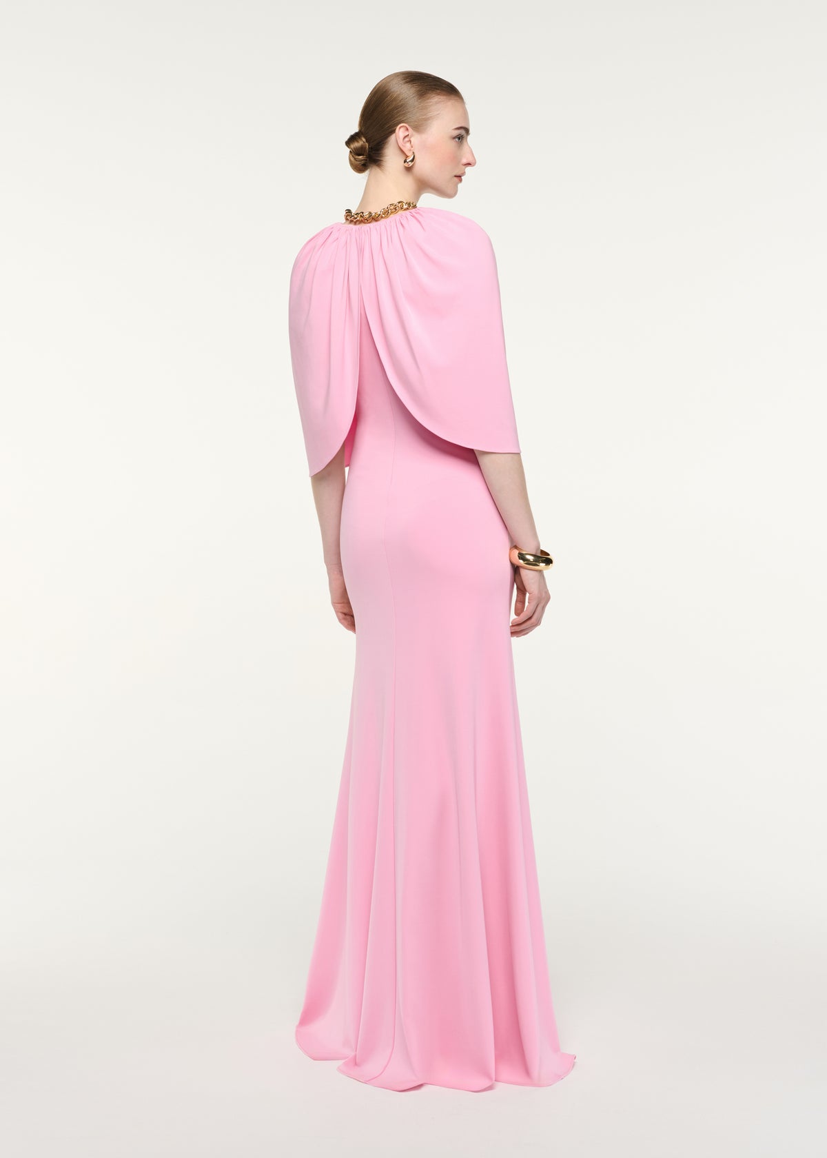 Back view of a model wearing the Gathered Cape Jersey Gown