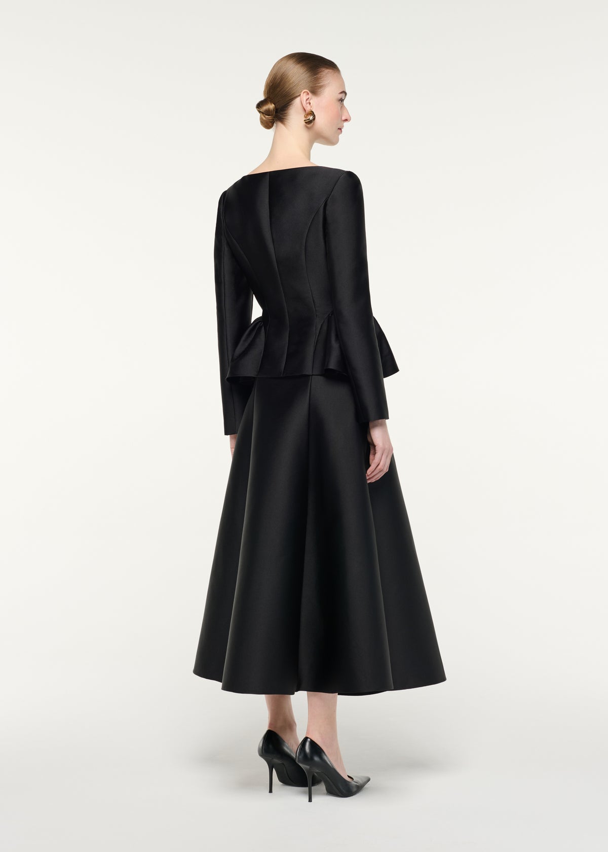 Back view of a model wearing the Full Midi Skirt