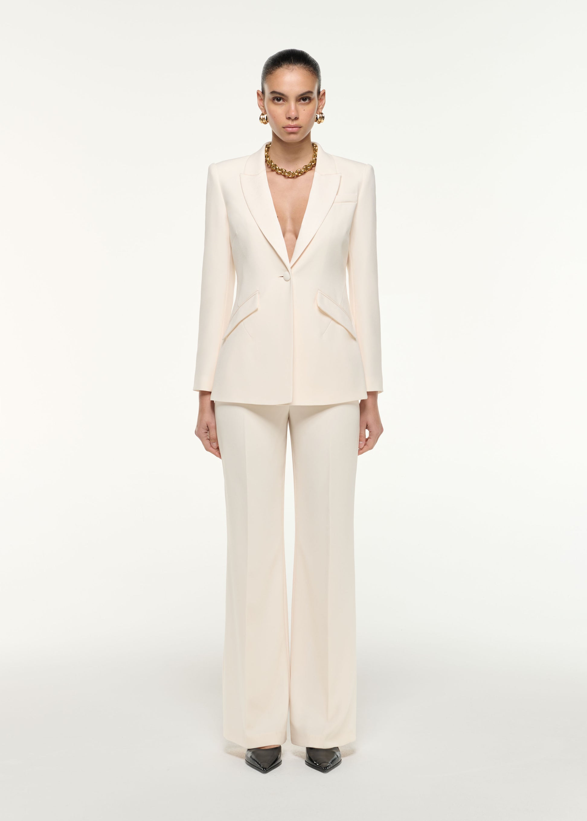 Front view of a model wearing the Satin Crepe Tailored Jacket in Cream