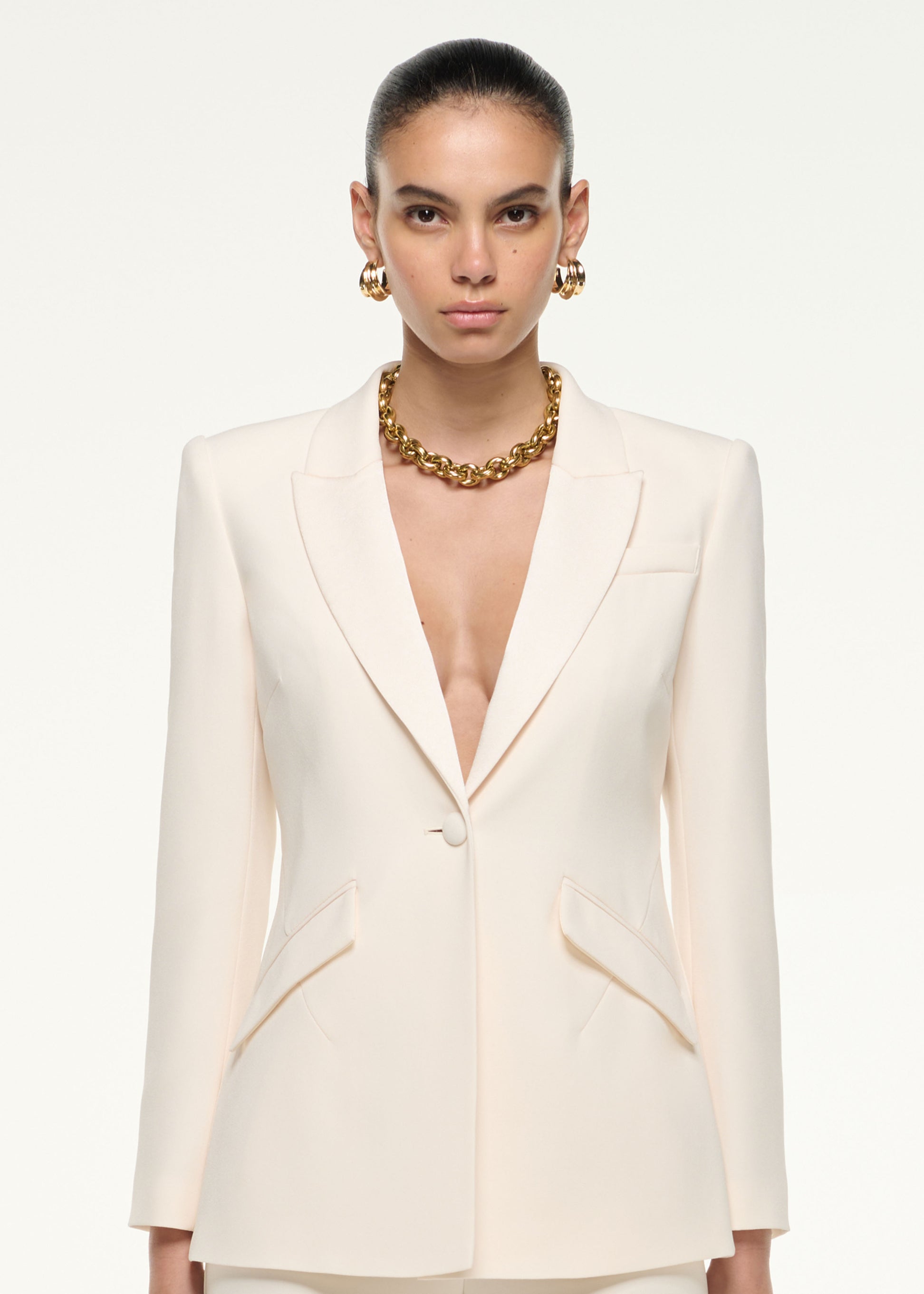 Close up of a model wearing the Satin Crepe Tailored Jacket in Cream