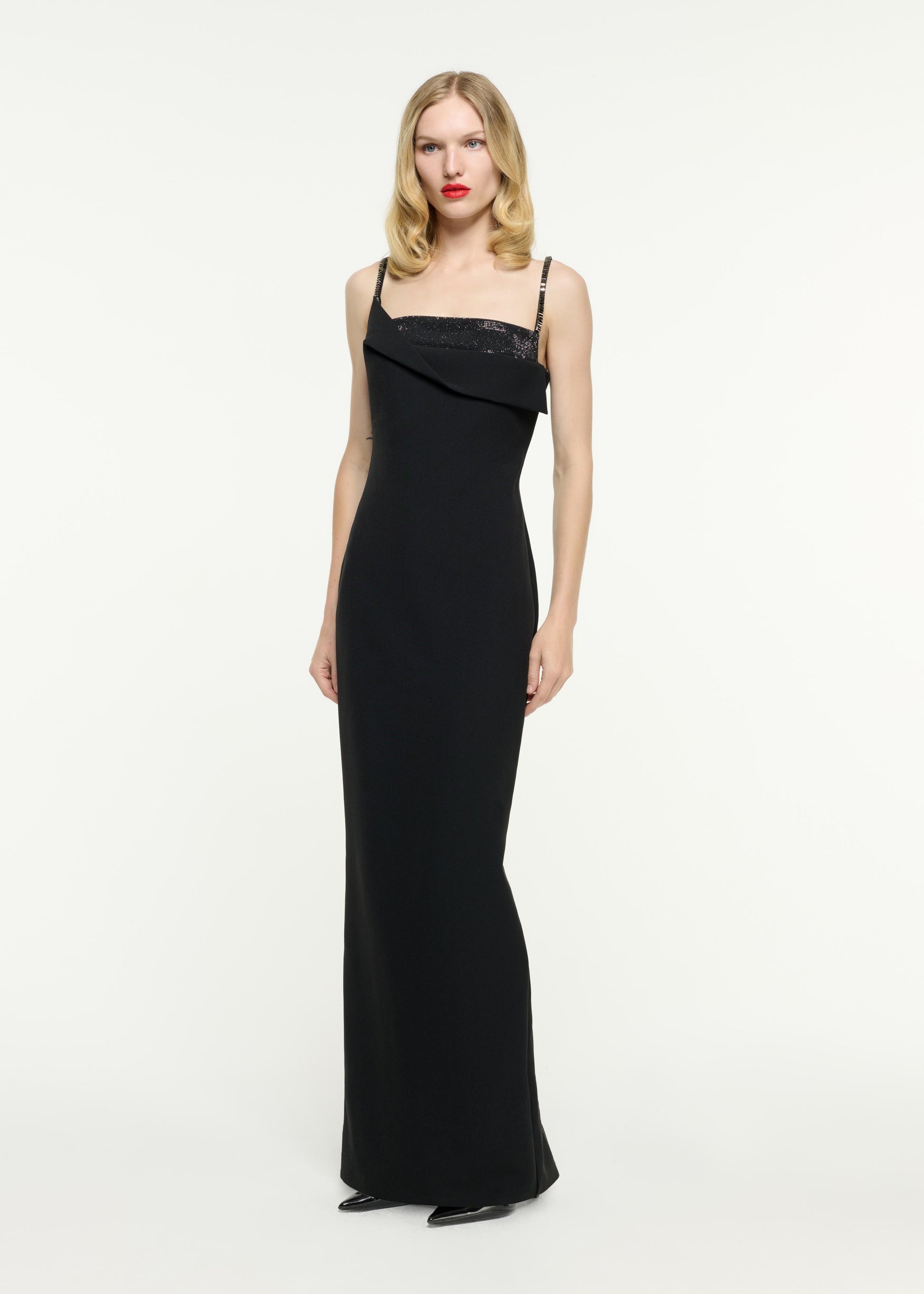 Side view of a model wearing the Embellished Crepe Gown in Black