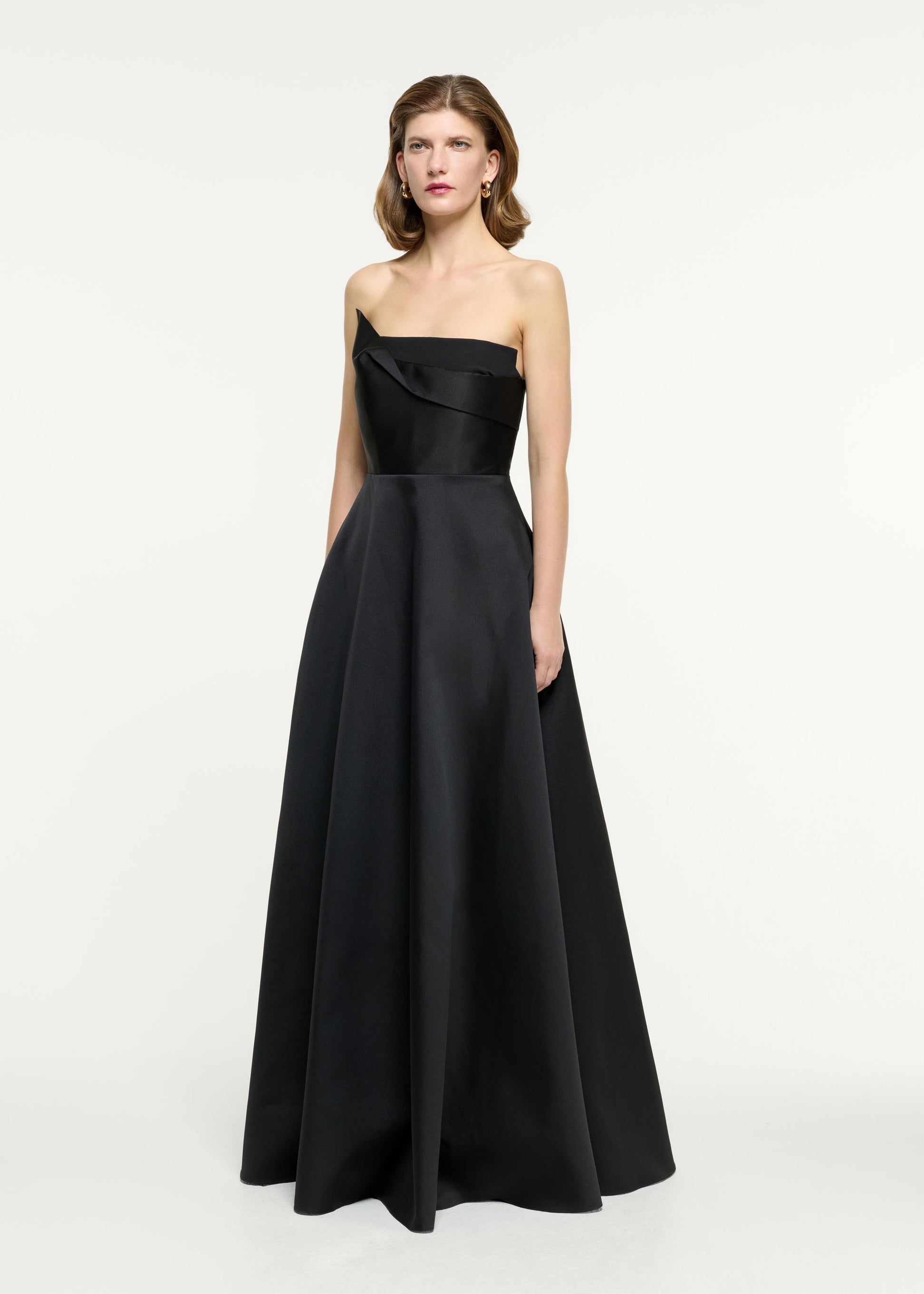 Side view of a model wearing the Strapless Taffeta Gown in Black
