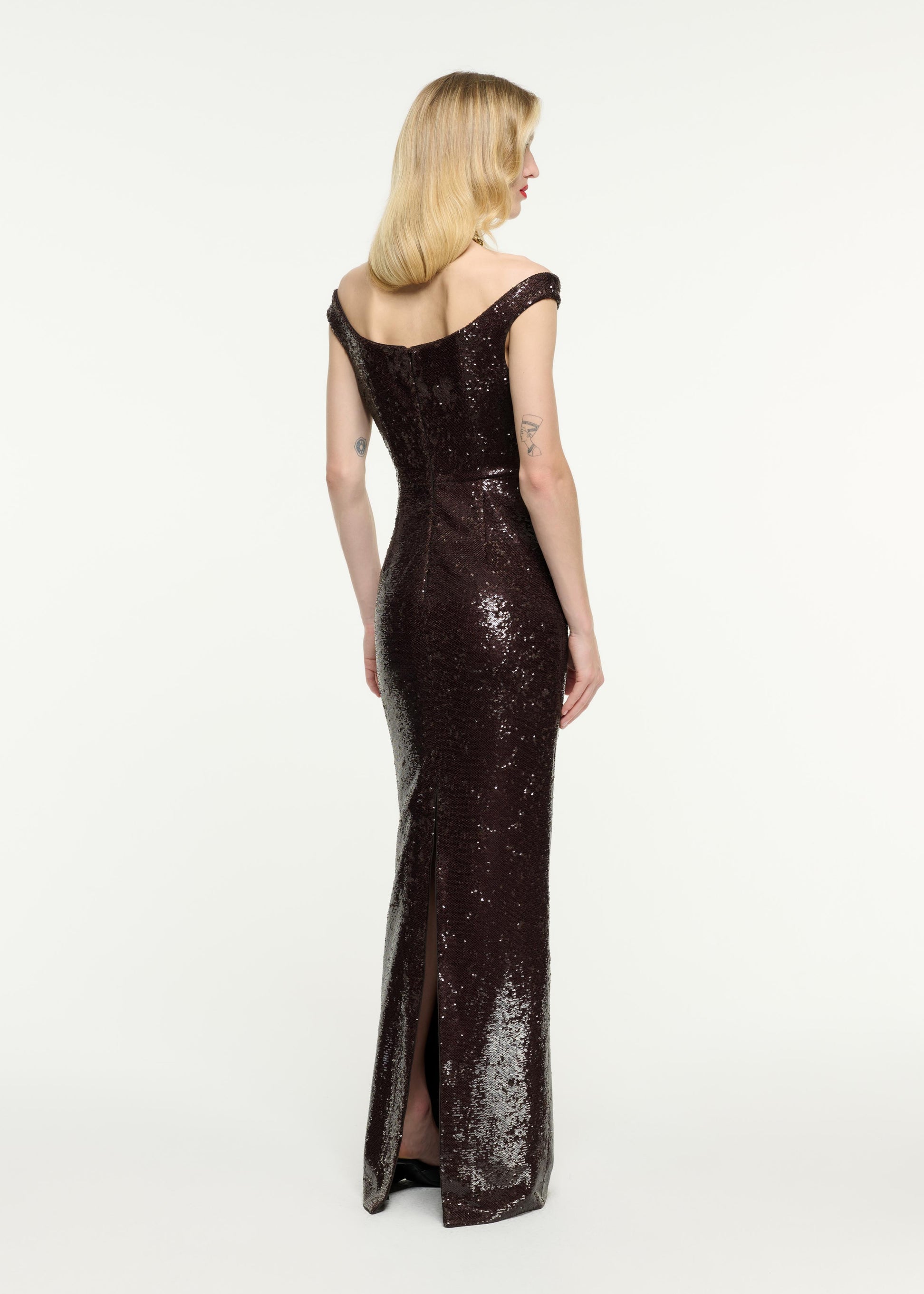 Back view of a model wearing the Off The Shoulder Sequin Gown in Brown