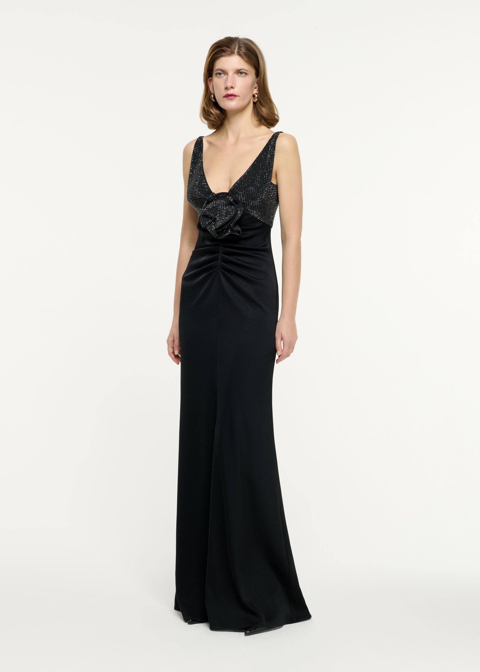 Side view of a model wearing the Embellished Flower Satin Crepe Gown in Black