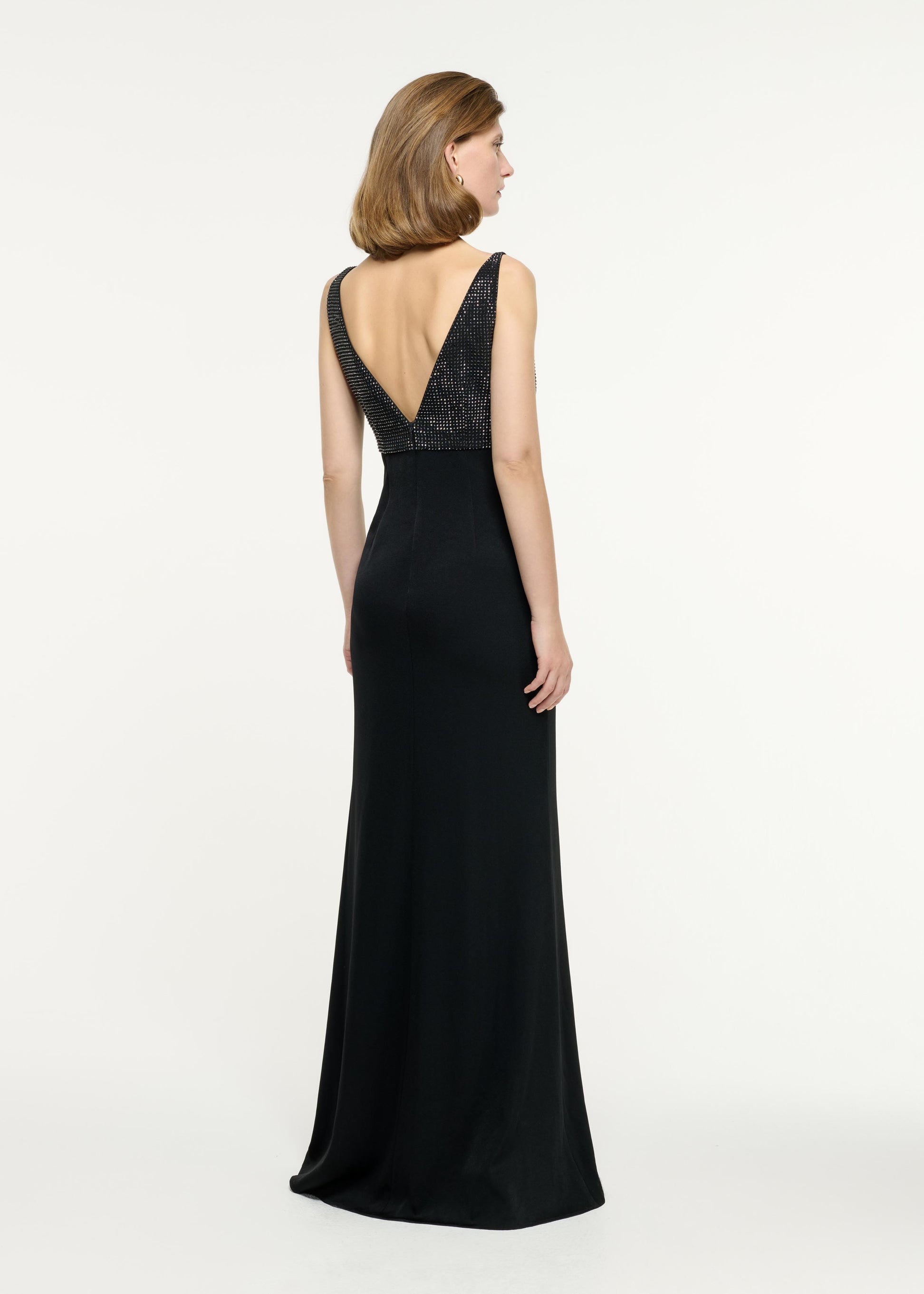 Back view of a model wearing the Embellished Flower Satin Crepe Gown in Black