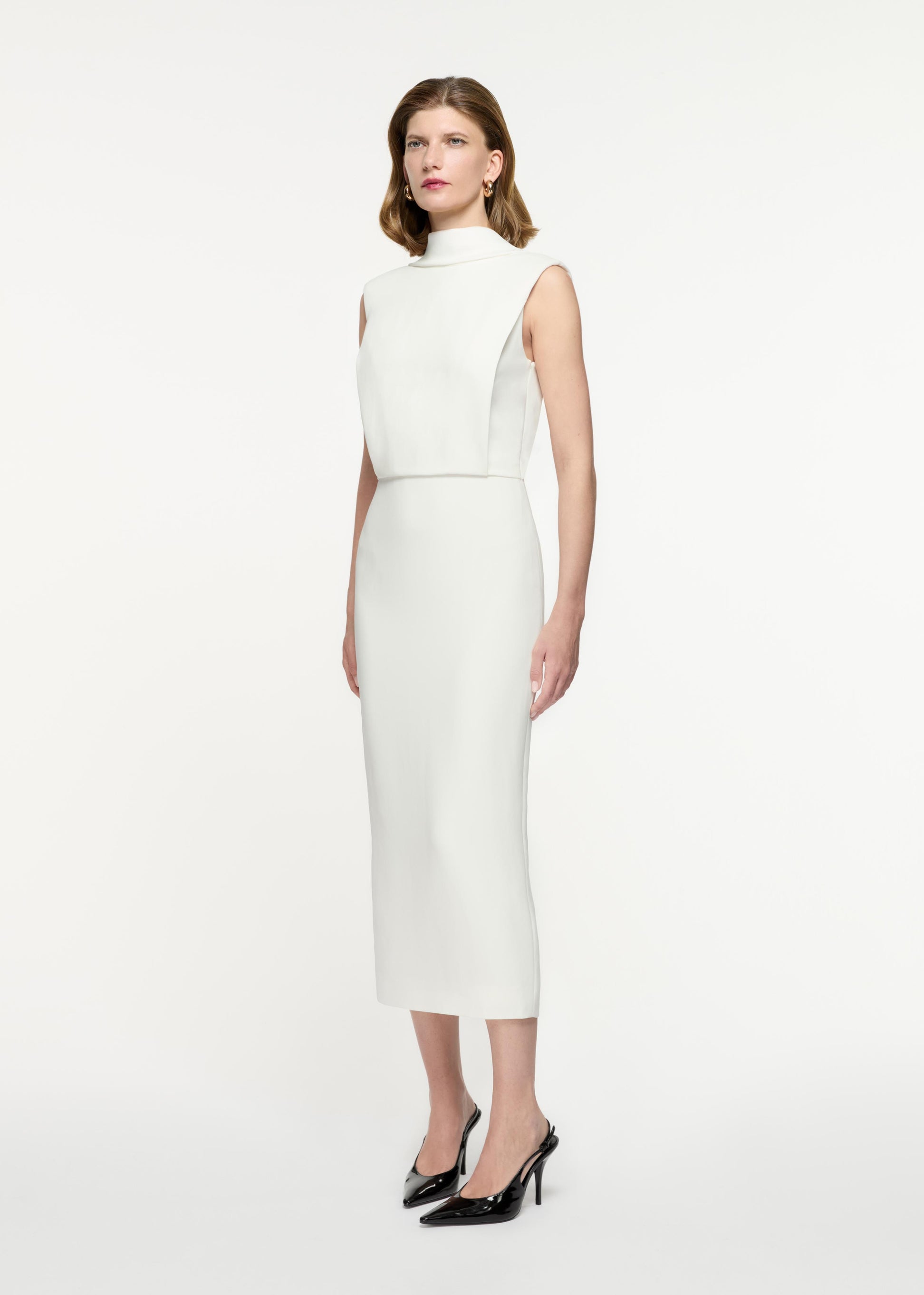 Side view of a model wearing the Stretch Cady Midi Dress in White