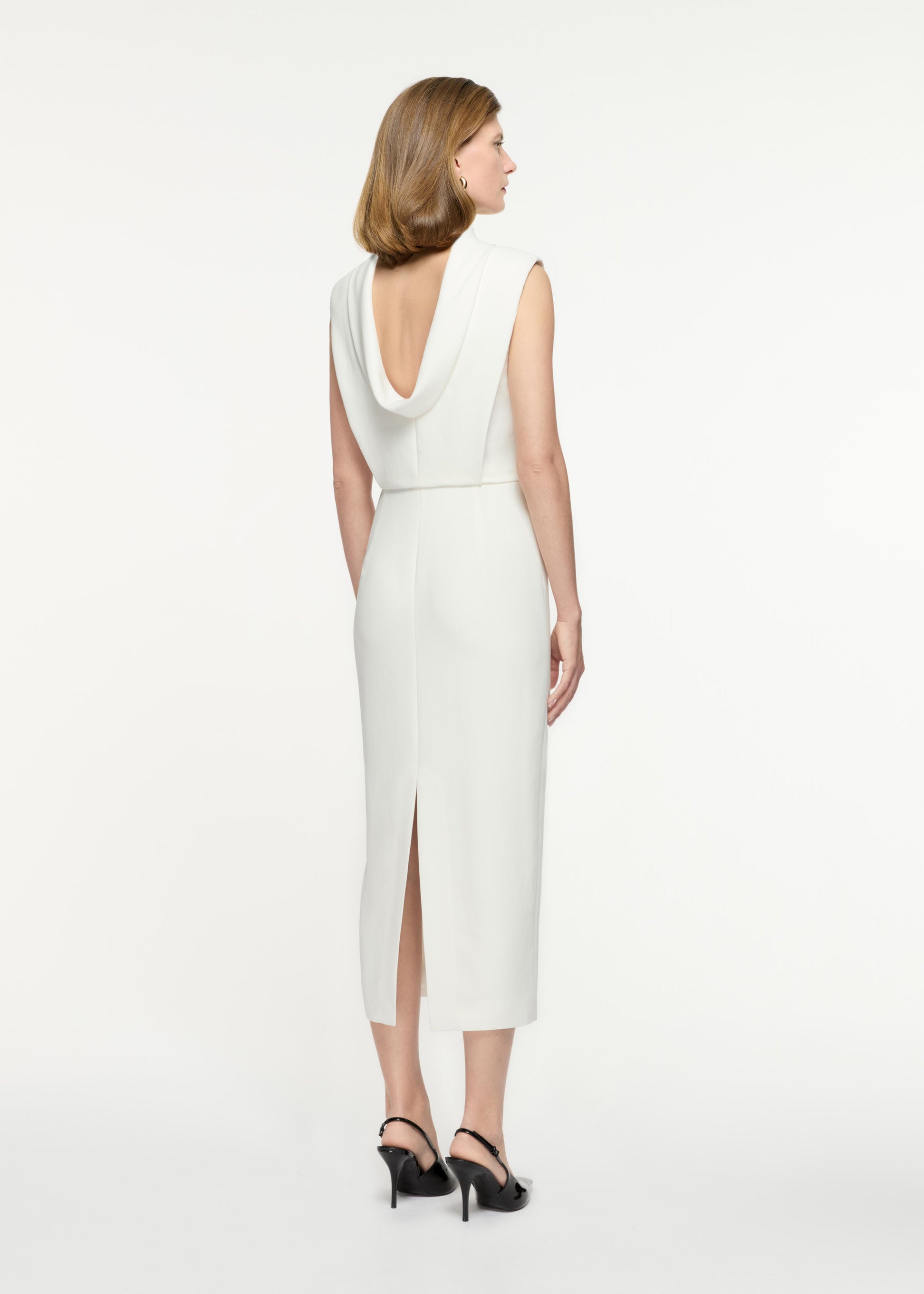 Back view of a model wearing the Stretch Cady Midi Dress in White