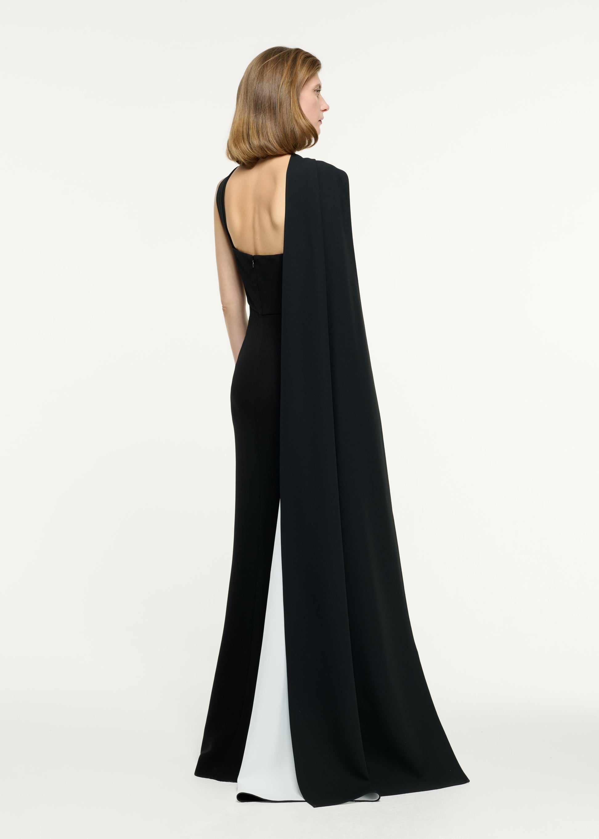 Back view of a model wearing the Asymmetric Buckle Gown in Monochrome
