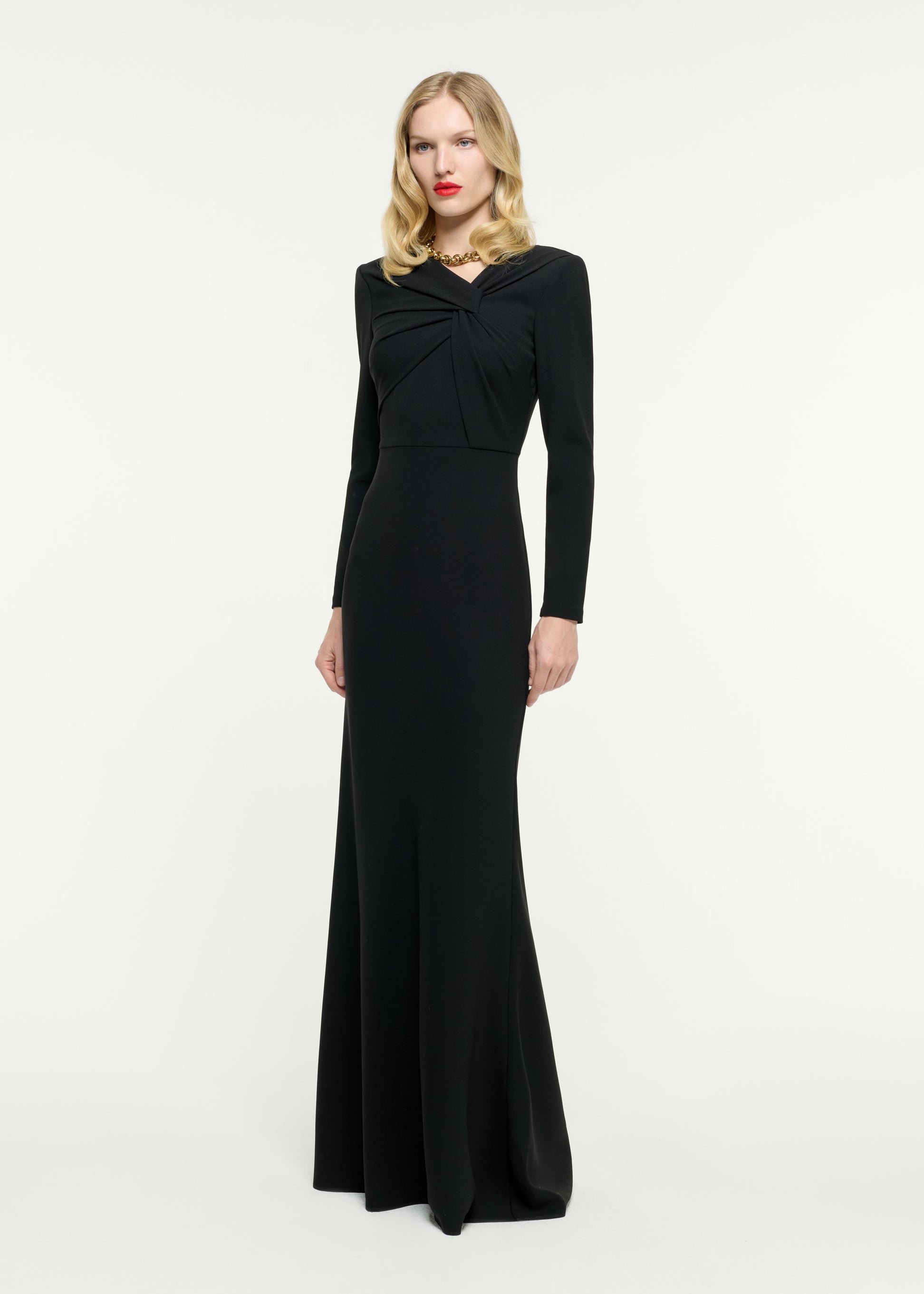 Side view of a model wearing the Long Sleeve Light Cady Gown in Black