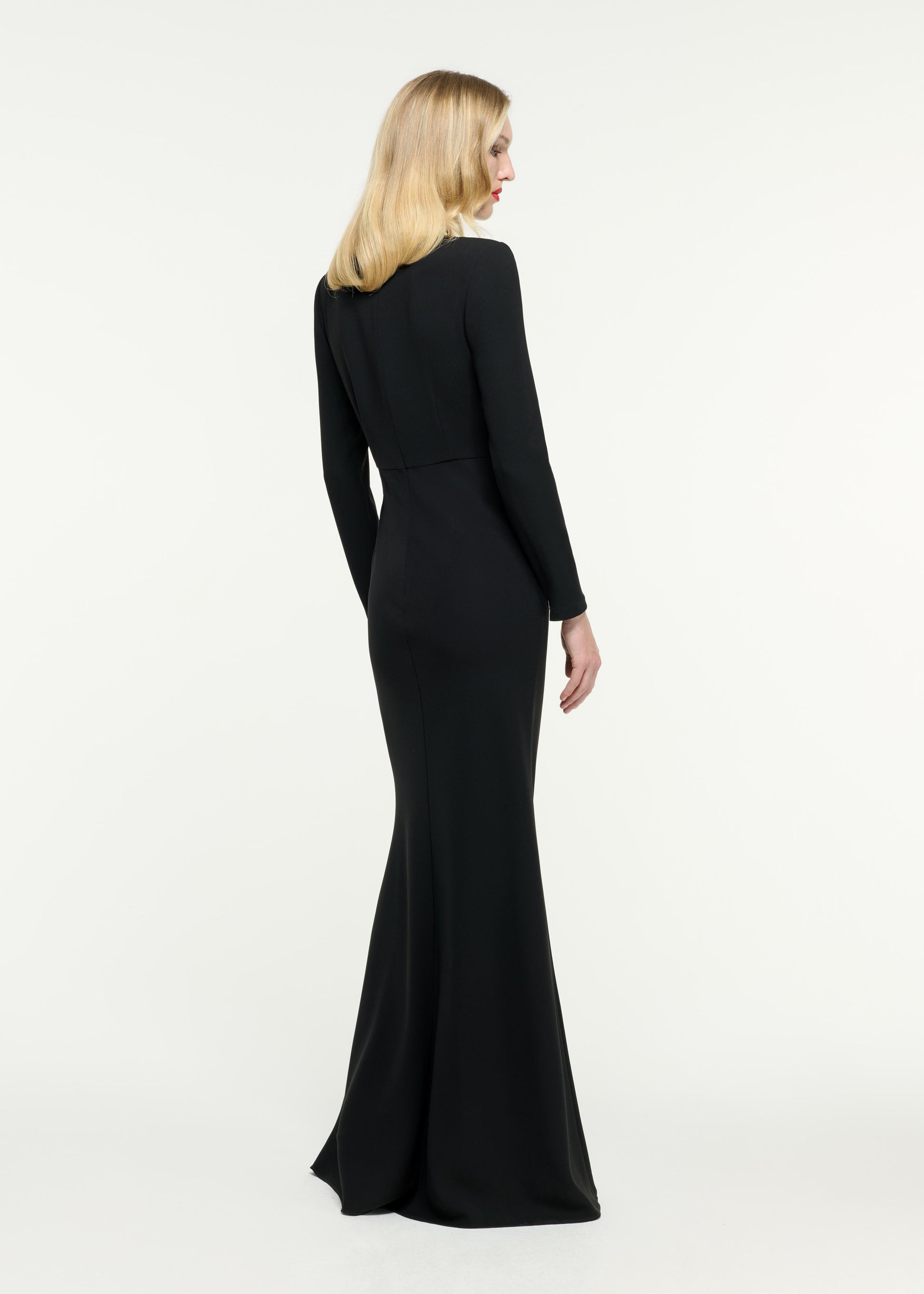 Back view of a model wearing the Long Sleeve Light Cady Gown in Black
