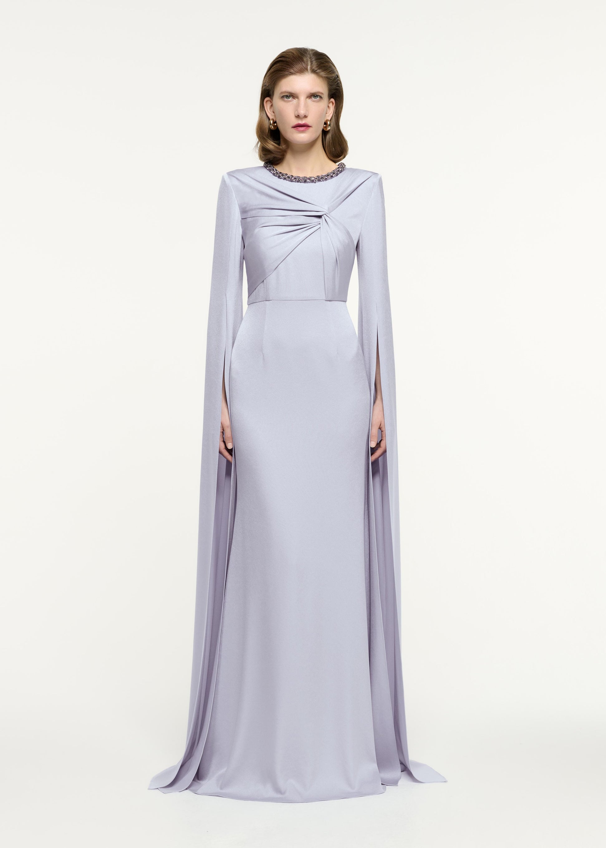 Front view of a model wearing the Cape Sleeve Embellished Gown in Lavender