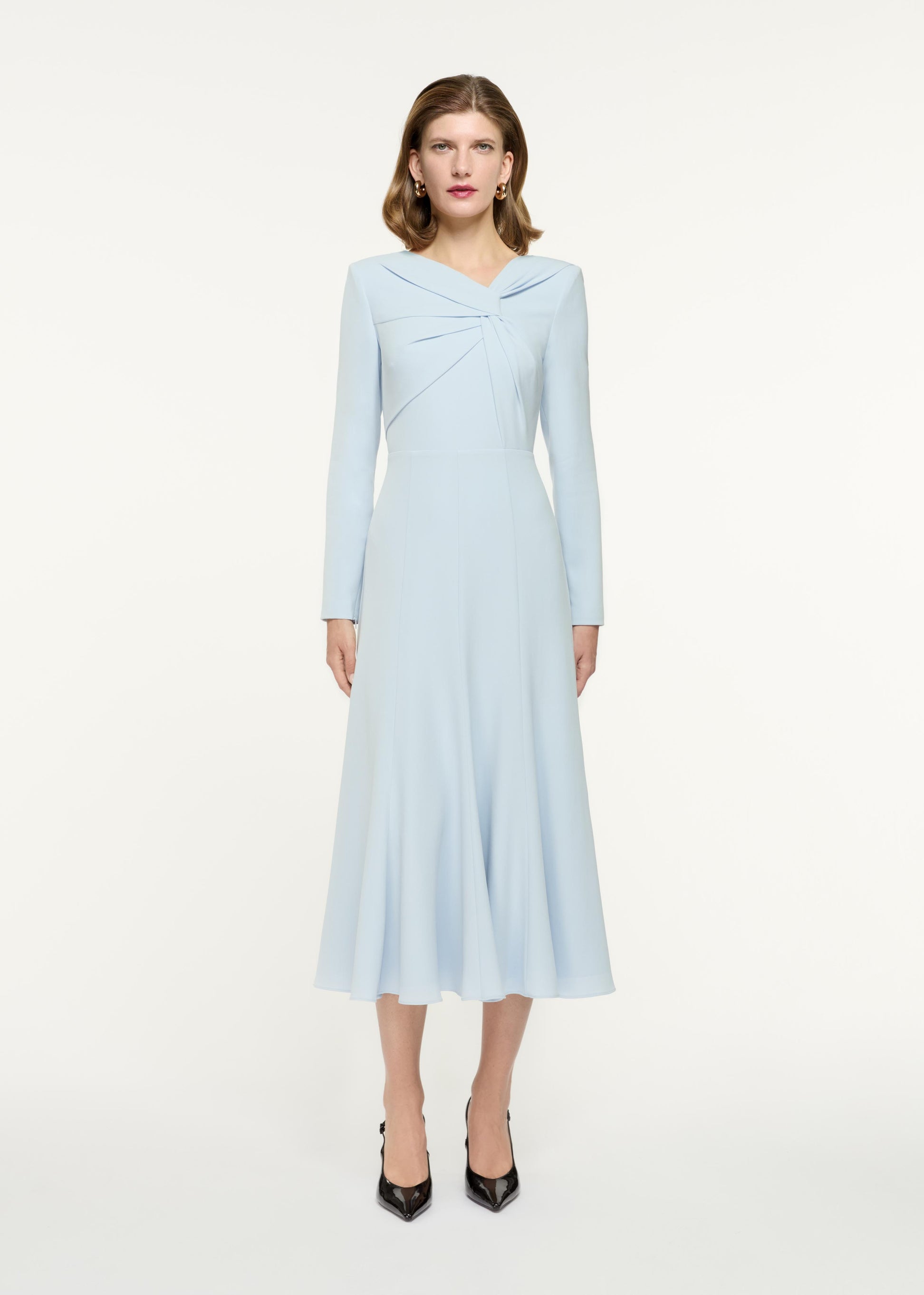 Front view of a model wearing the Long Sleeve Light Cady Midi Dress in Blue