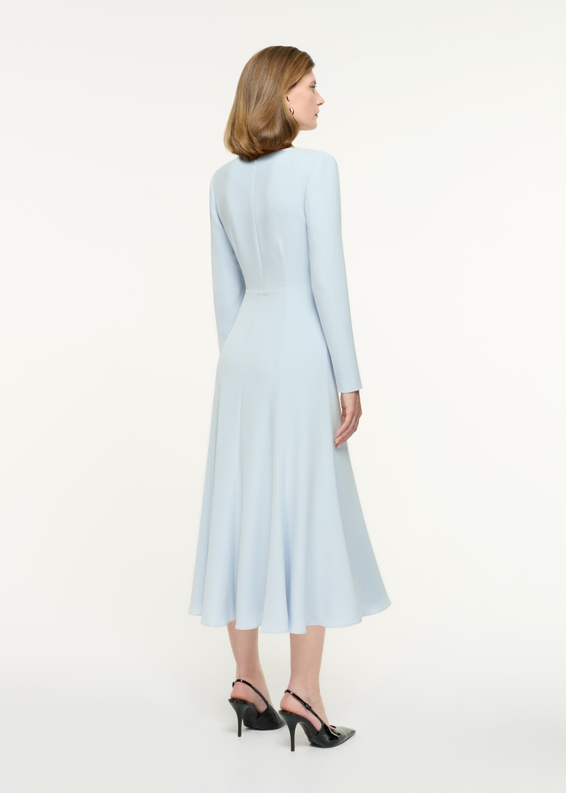 Side view of a model wearing the Long Sleeve Light Cady Midi Dress in Blue