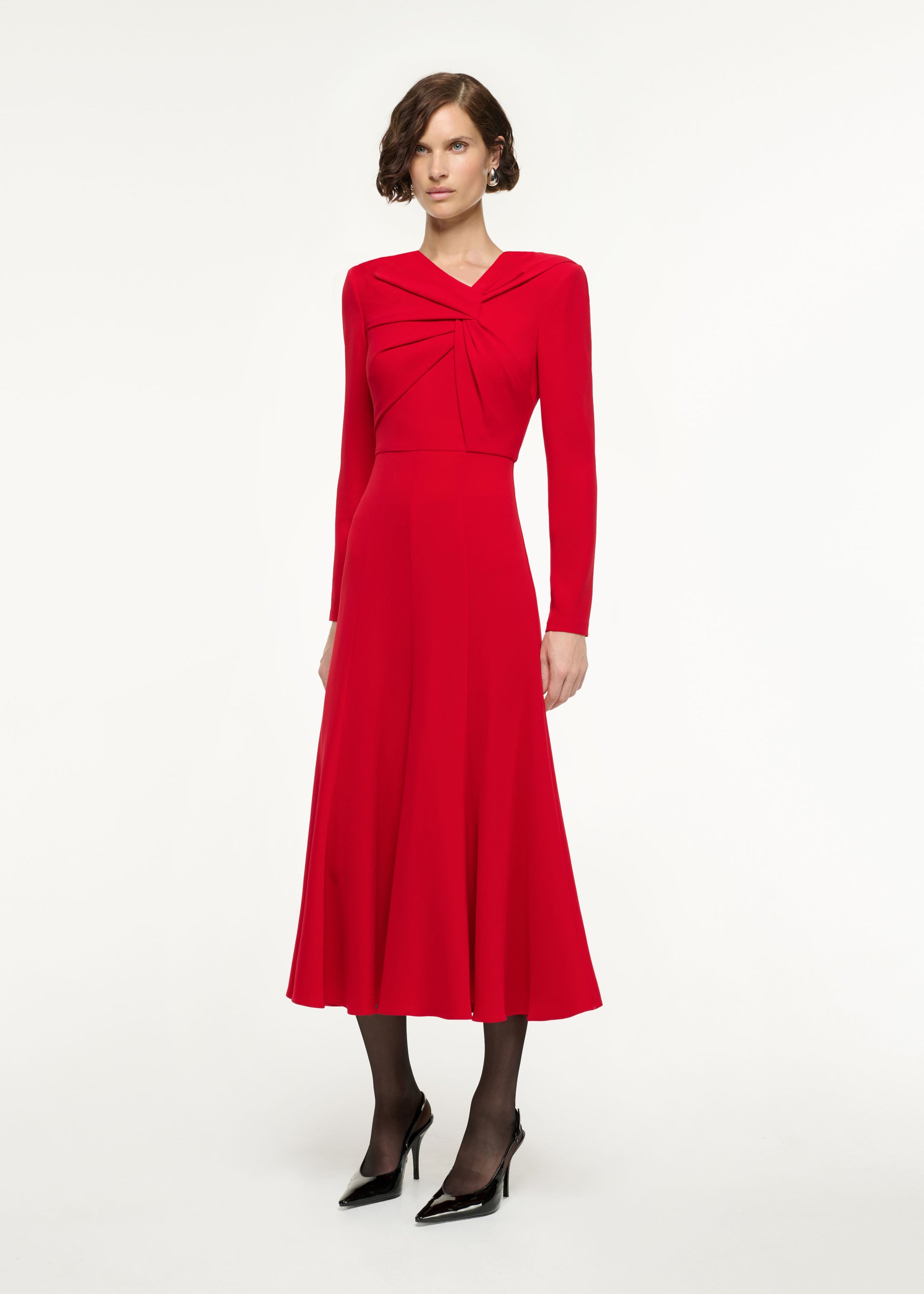 Side view of a model wearing the Long Sleeve Light Cady Midi Dress in Red
