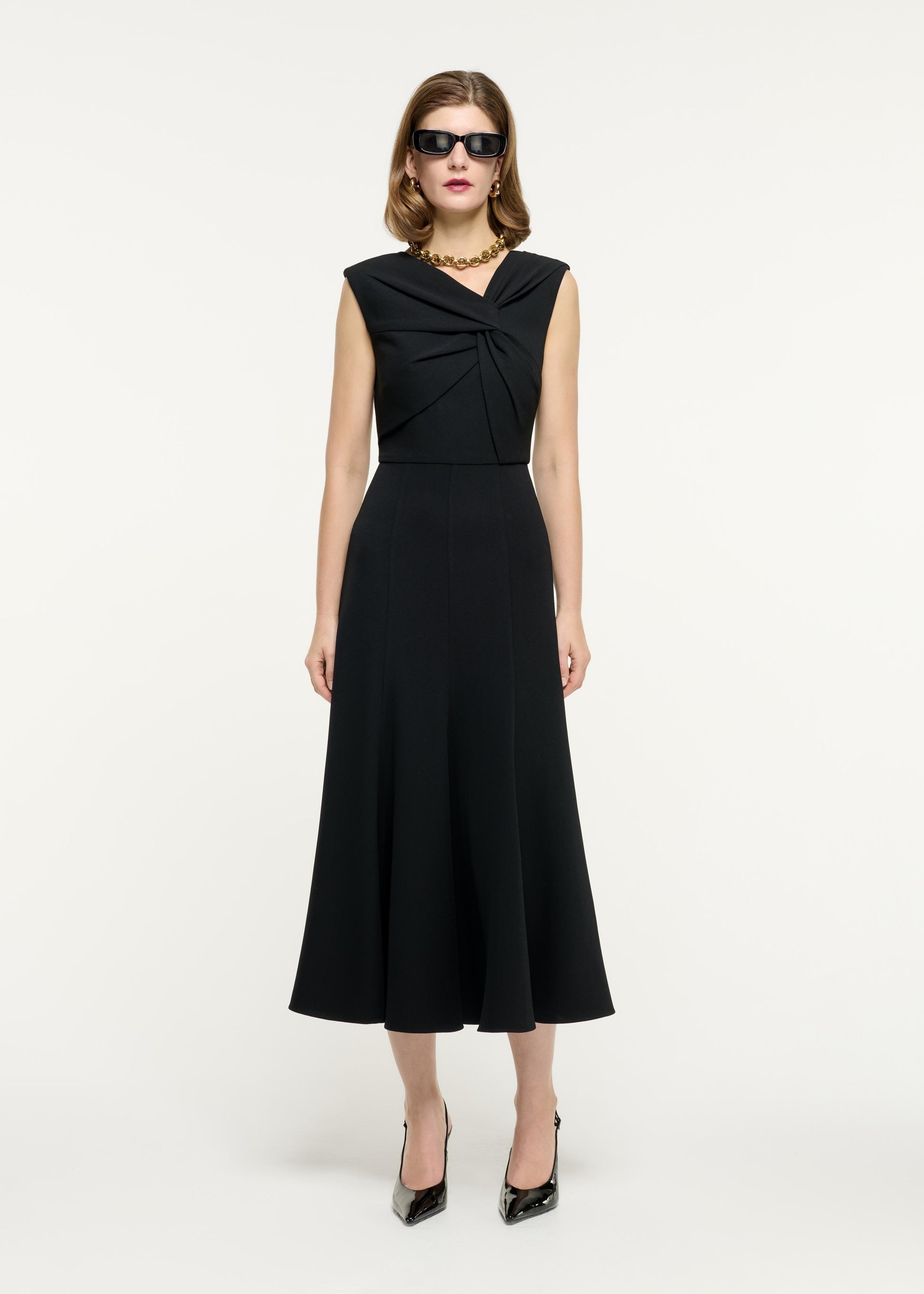 Front view of a model wearing the Sleeveless Light Cady Midi Dress in Black