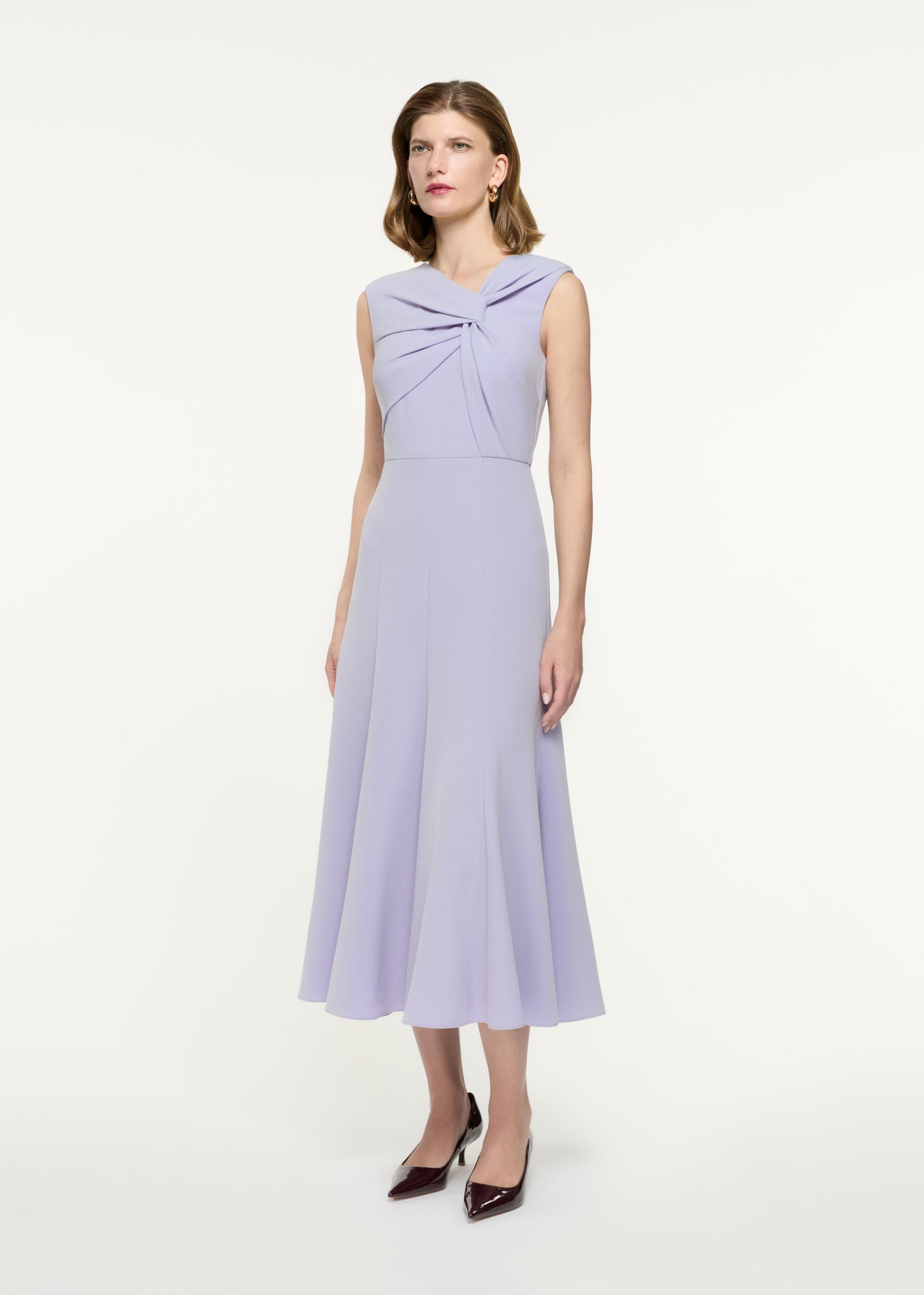 Side view of a model wearing the Sleeveless Light Cady Midi Dress in Purple