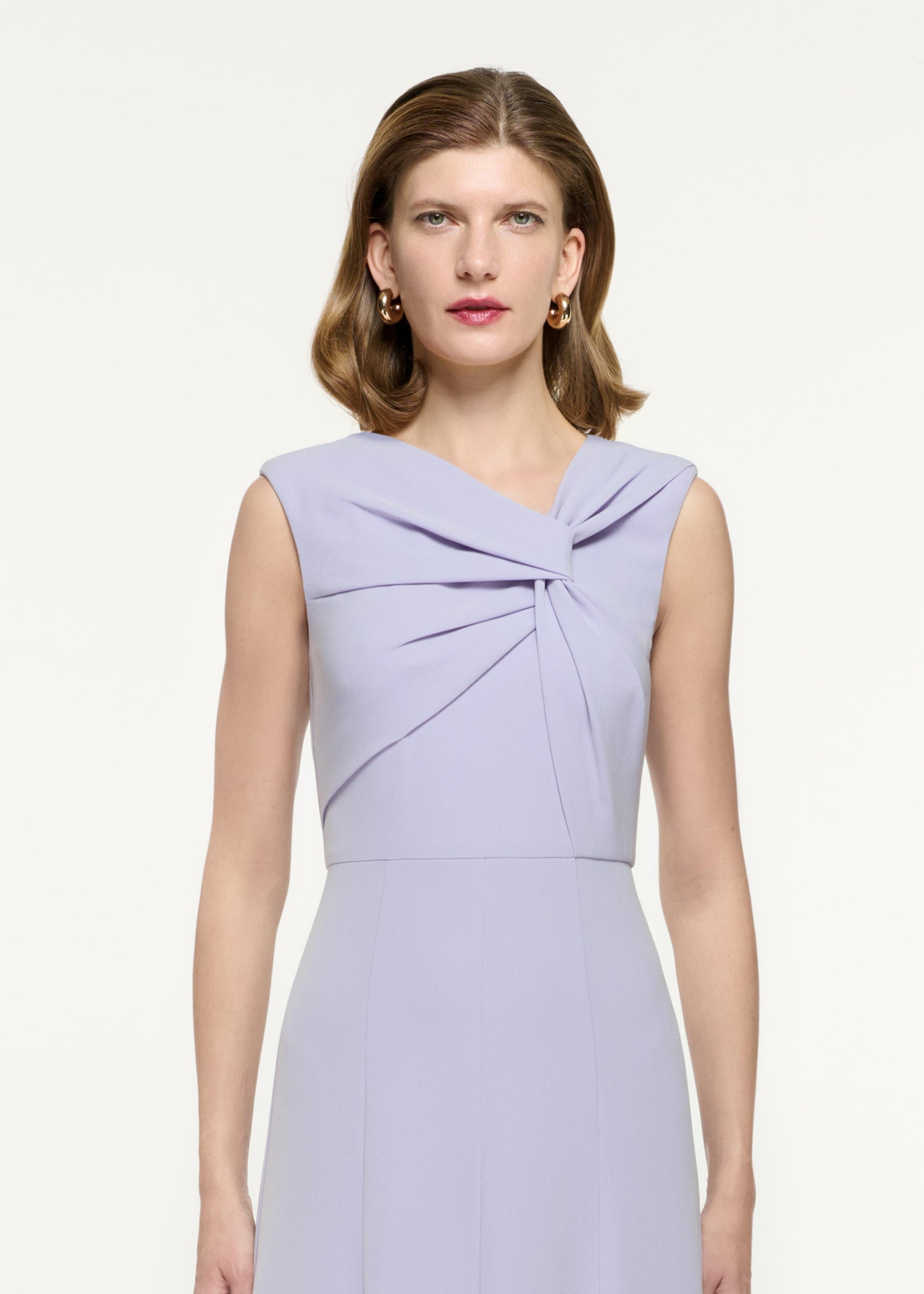 Close up of a model wearing the Sleeveless Light Cady Midi Dress in Purple