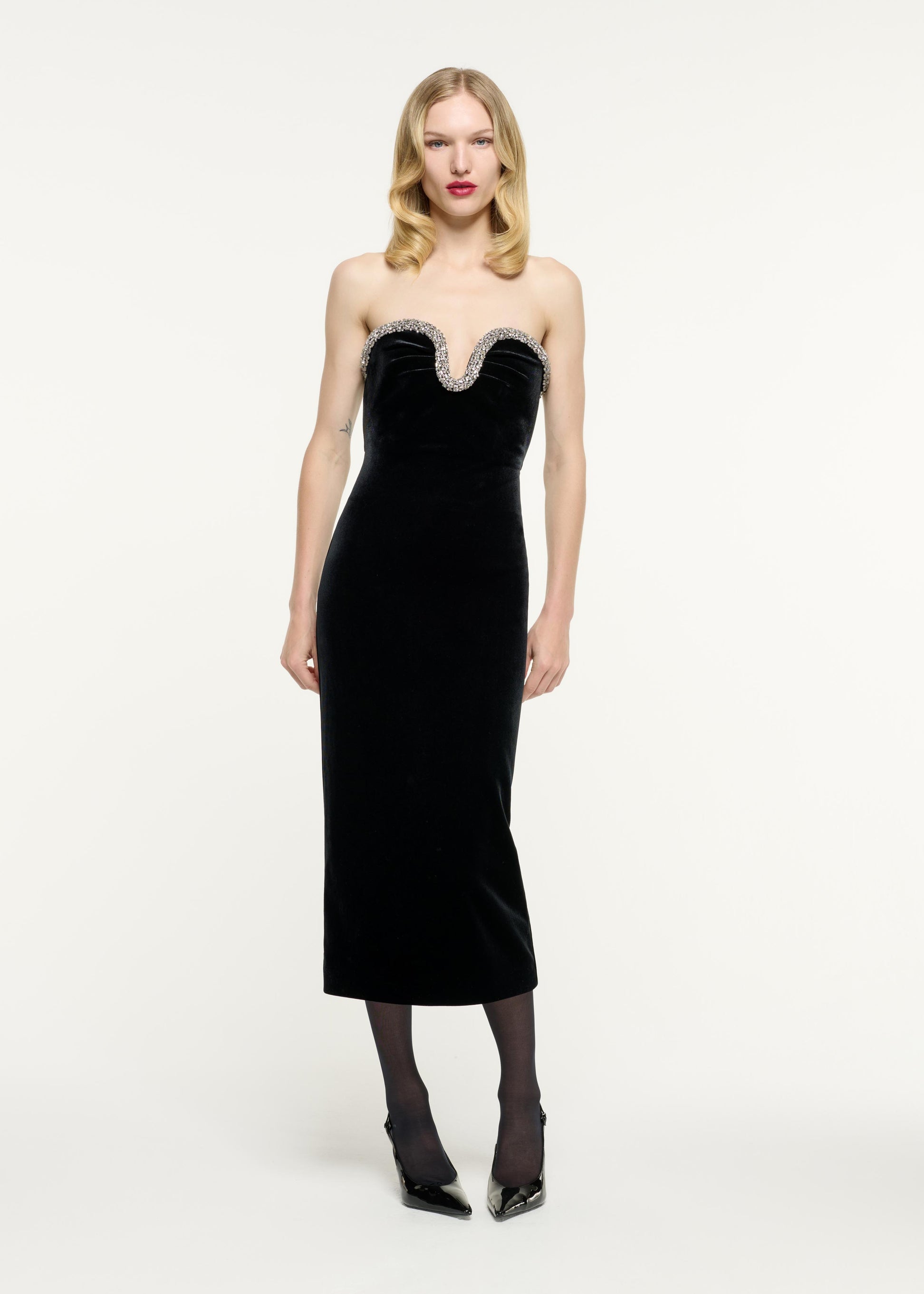 Front view of a model wearing the Strapless Embellished Velvet Midi Dress in Black