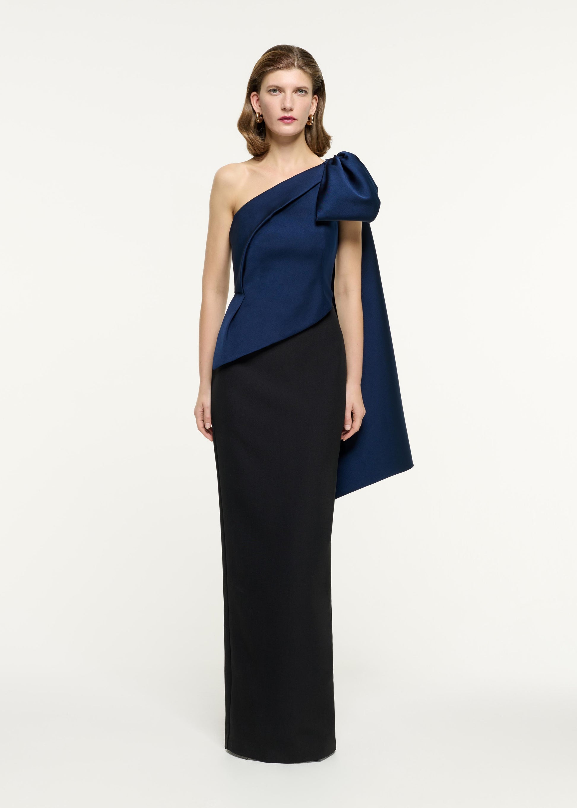 Front view of a model wearing the Asymmetric Taffeta Bow Drape Gown in Navy