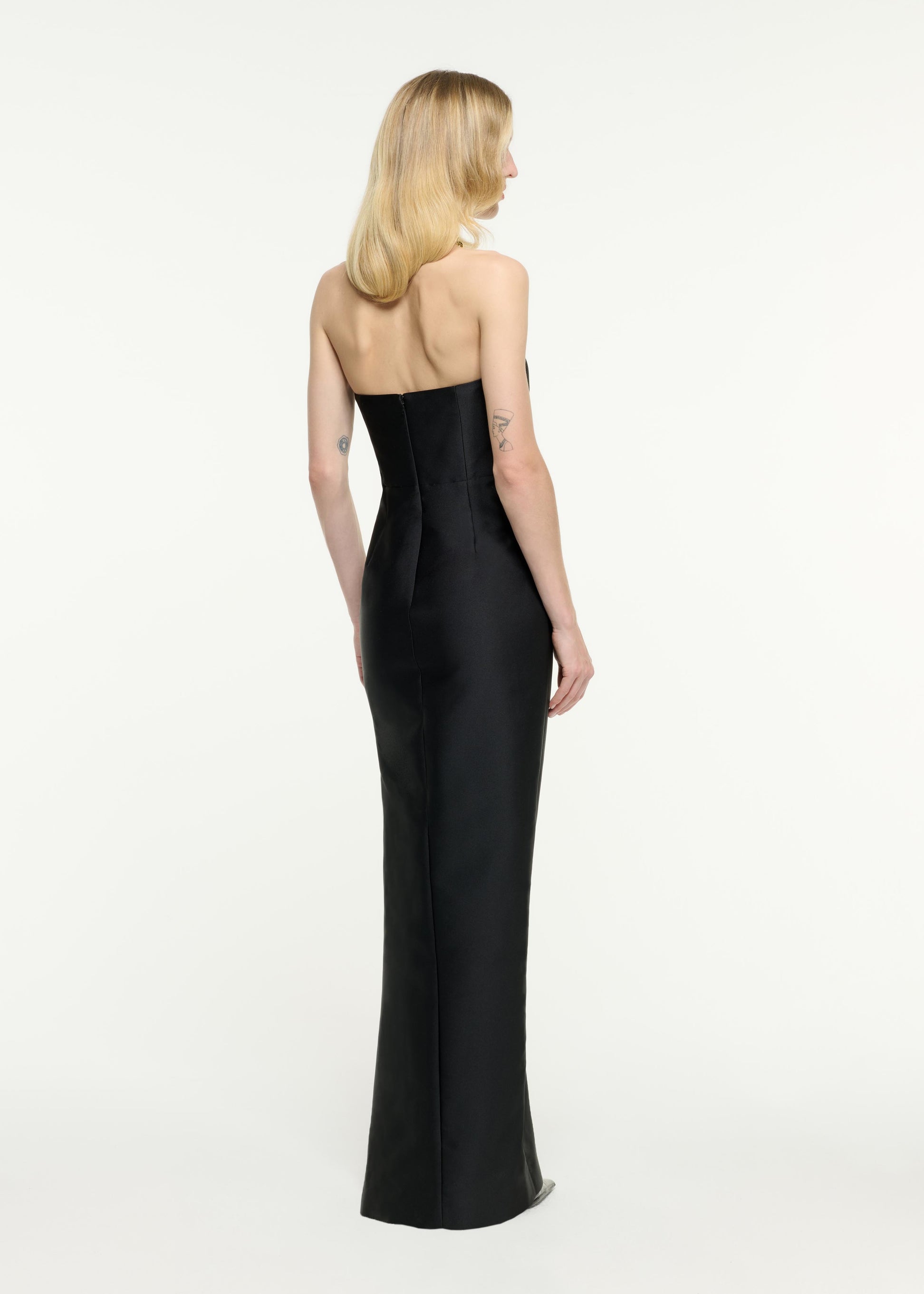 Back view of a model wearing the Strapless Sweet Heart Taffeta Gown in Black