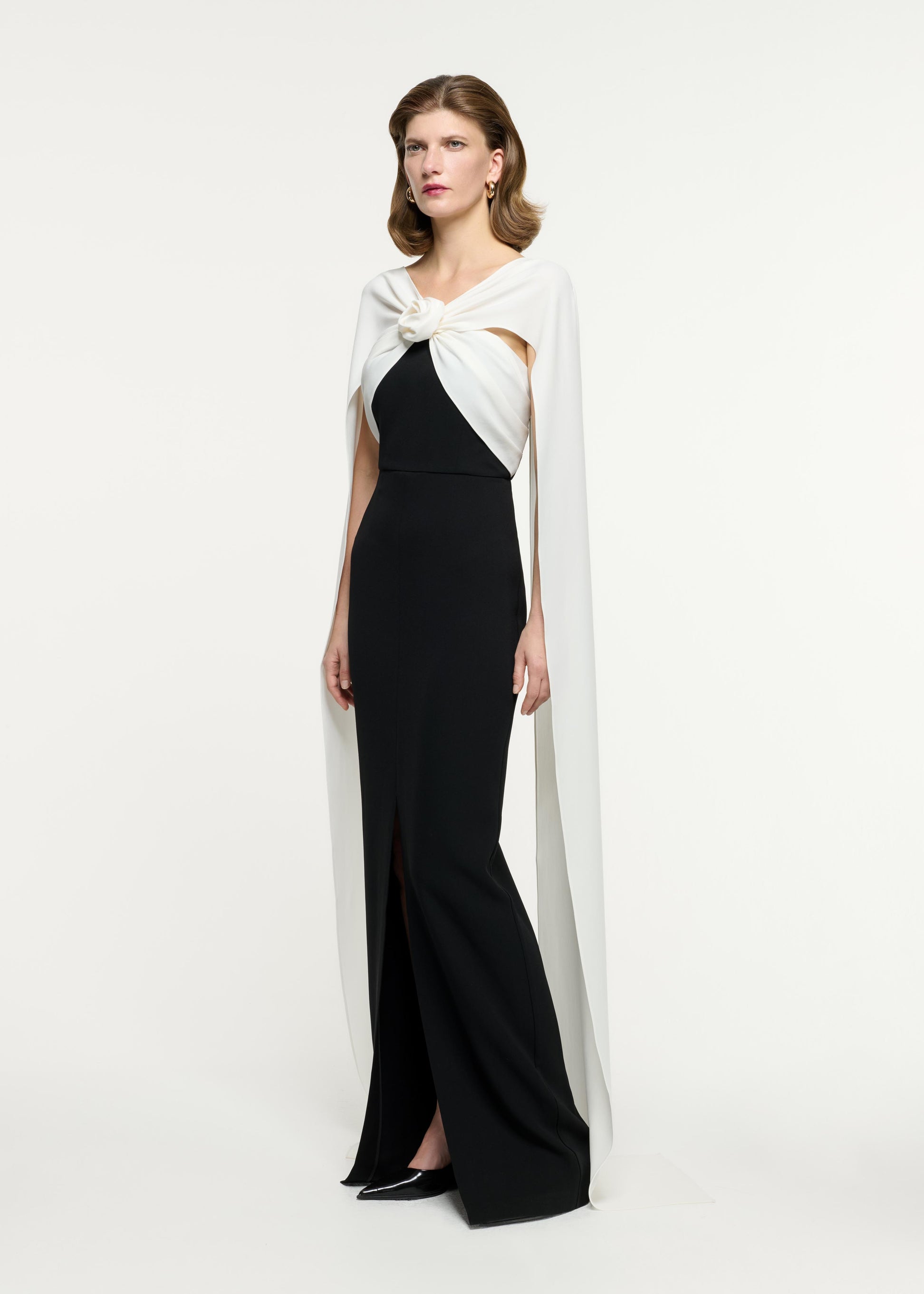 Side view of a model wearing the Cape Flower Cady Gown in Monochrome