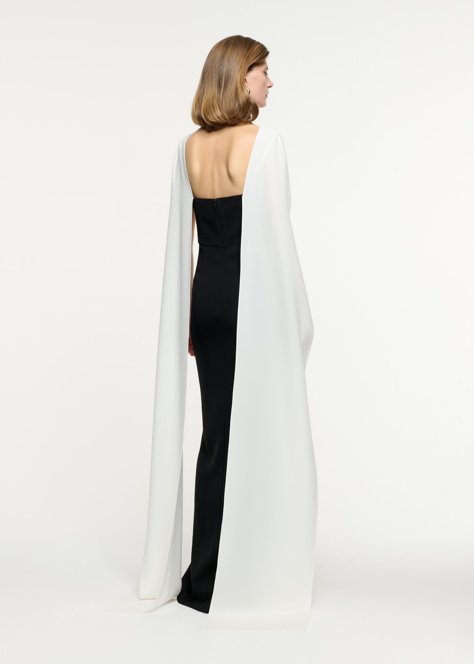 Back view of a model wearing the Cape Flower Cady Gown in Monochrome