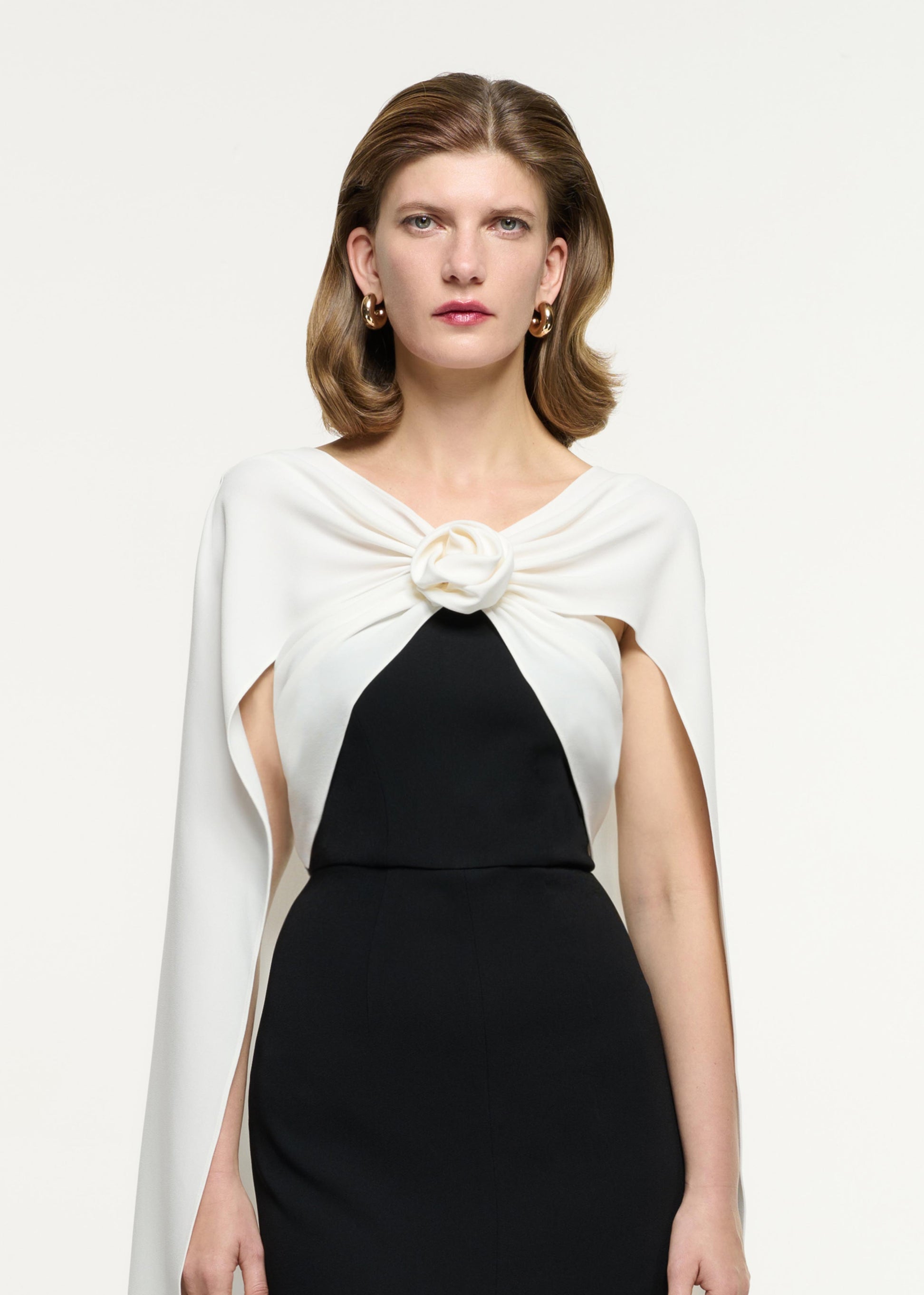 Close up of a model wearing the Cape Flower Cady Gown in Monochrome