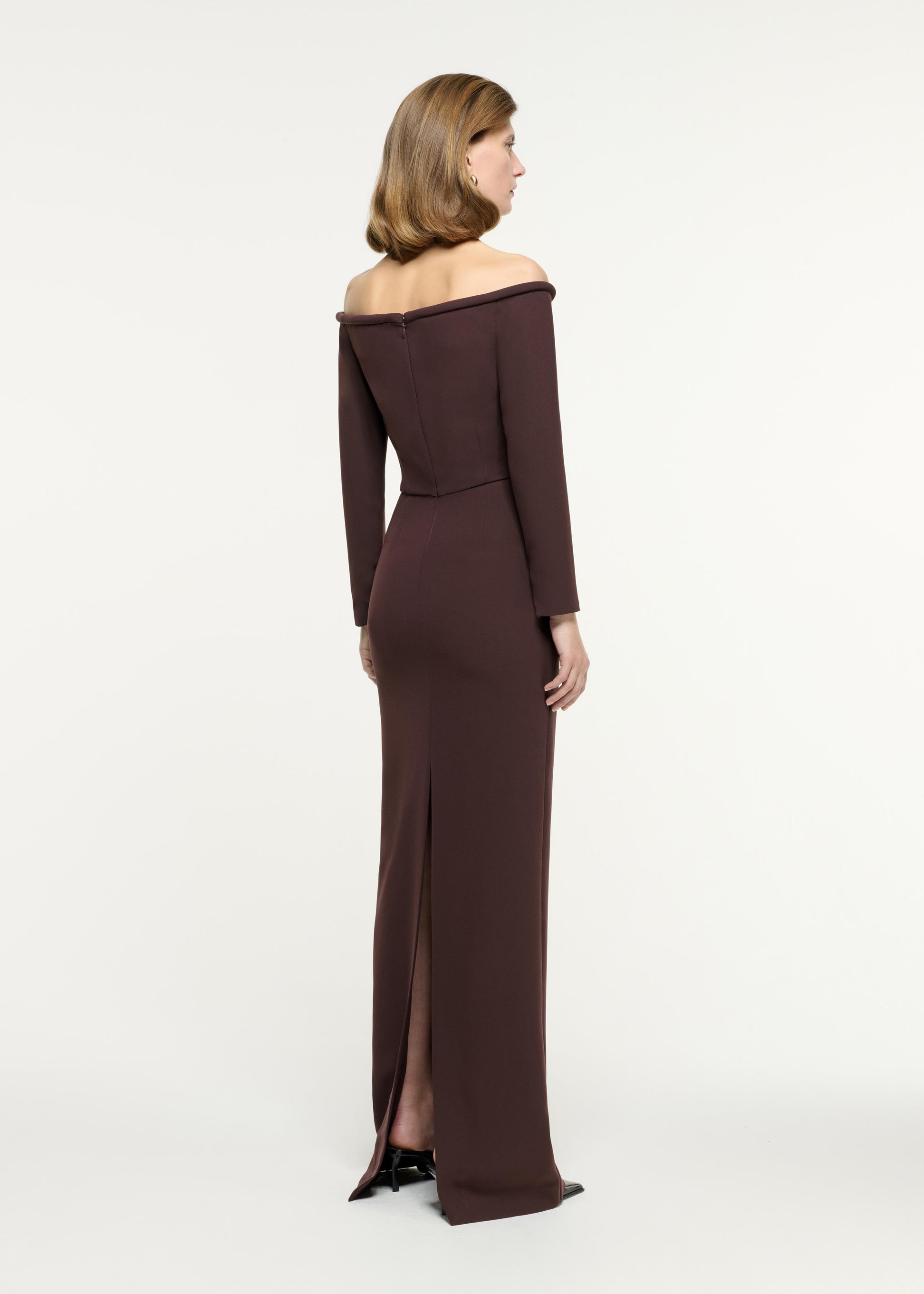 Back view of a model wearing the Long Sleeve Embellished Heavy Cady Gown in Brown