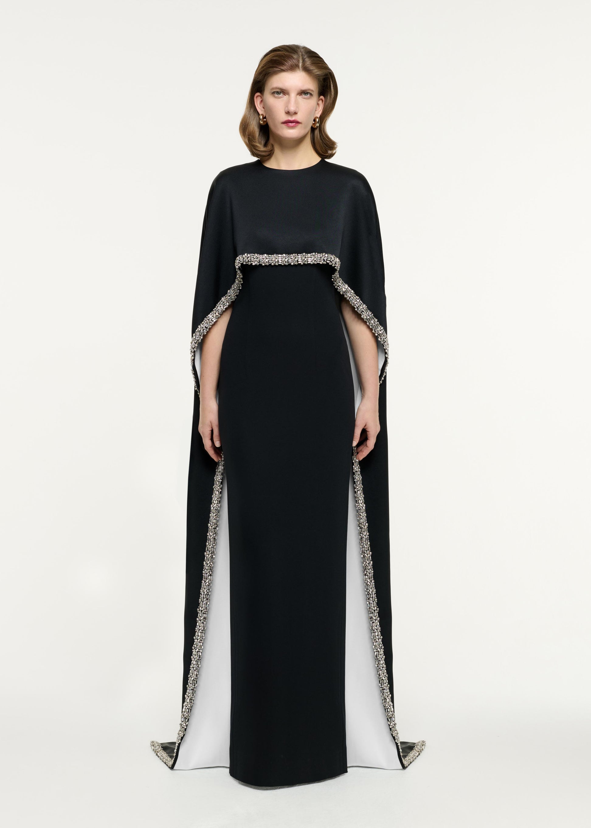 Front view of a model wearing the Embellished Cape Satin Crepe Gown in Monochrome