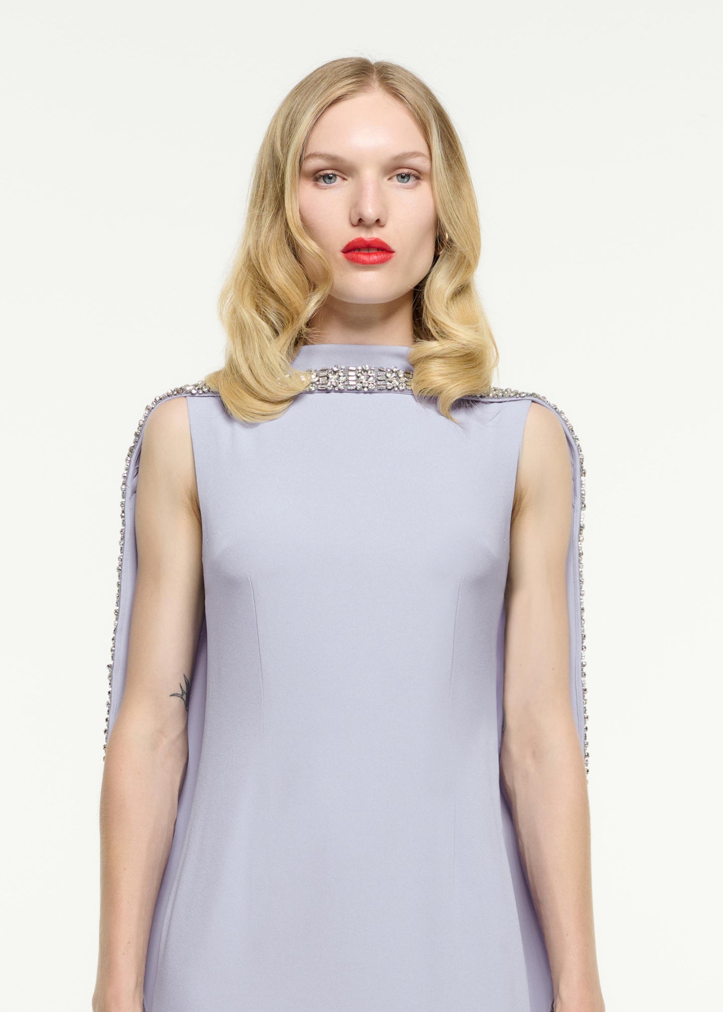 Close up of a model wearing the Embellished Cape Satin Crepe Gown in Purple