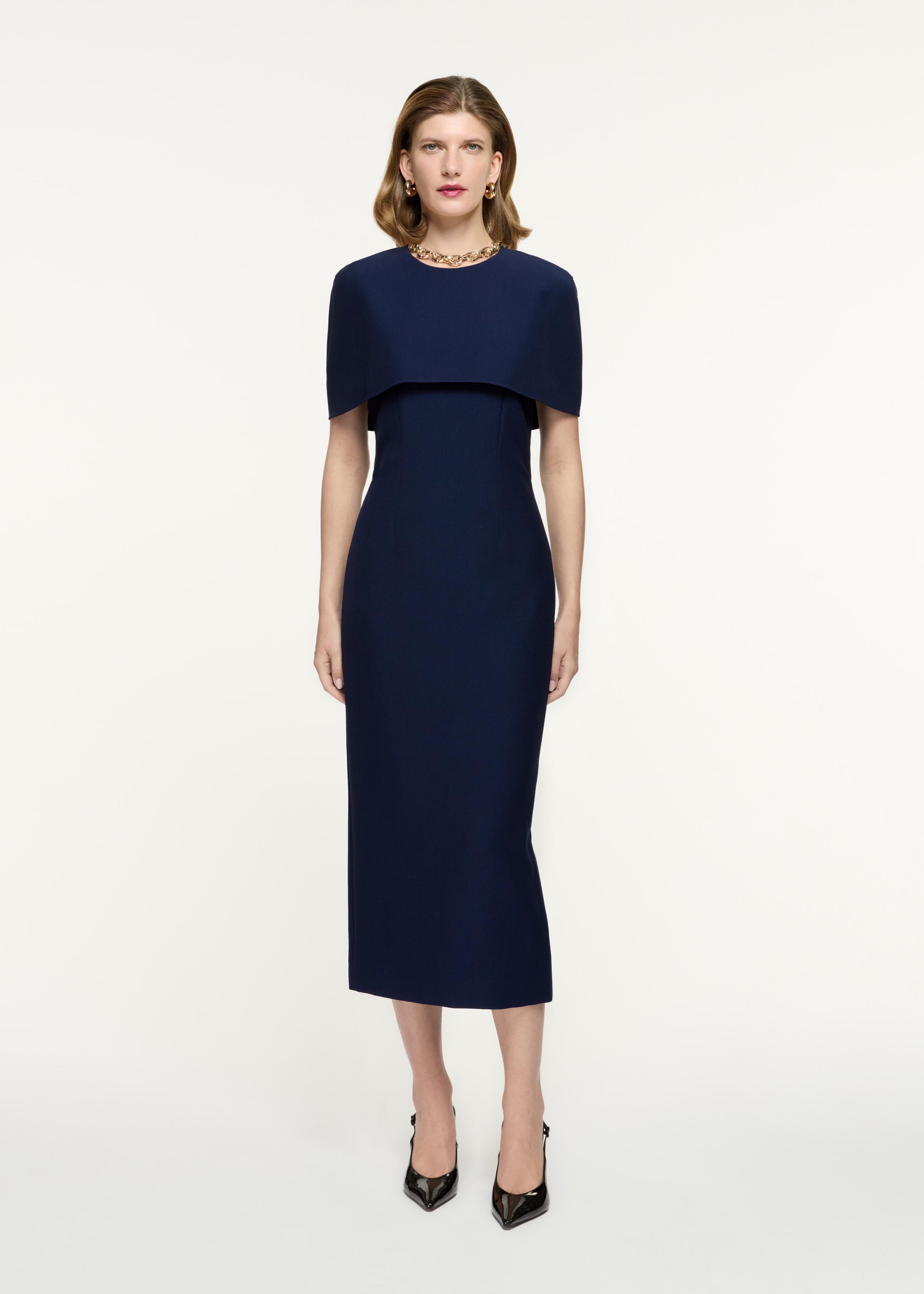 Front view of a model wearing the Cape Crepe Midi Dress in Navy
