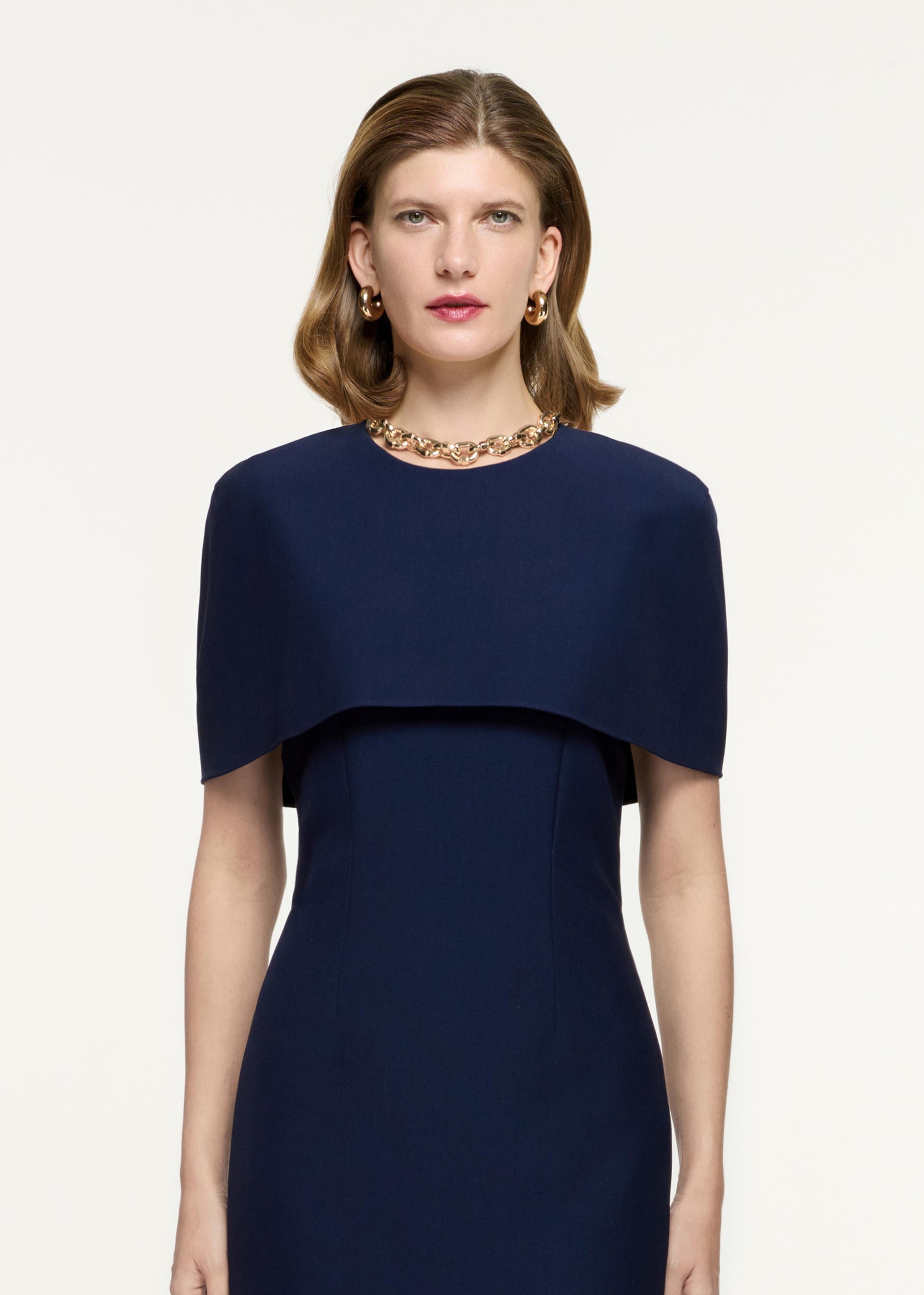 Close up of a model wearing the Cape Crepe Midi Dress in Navy