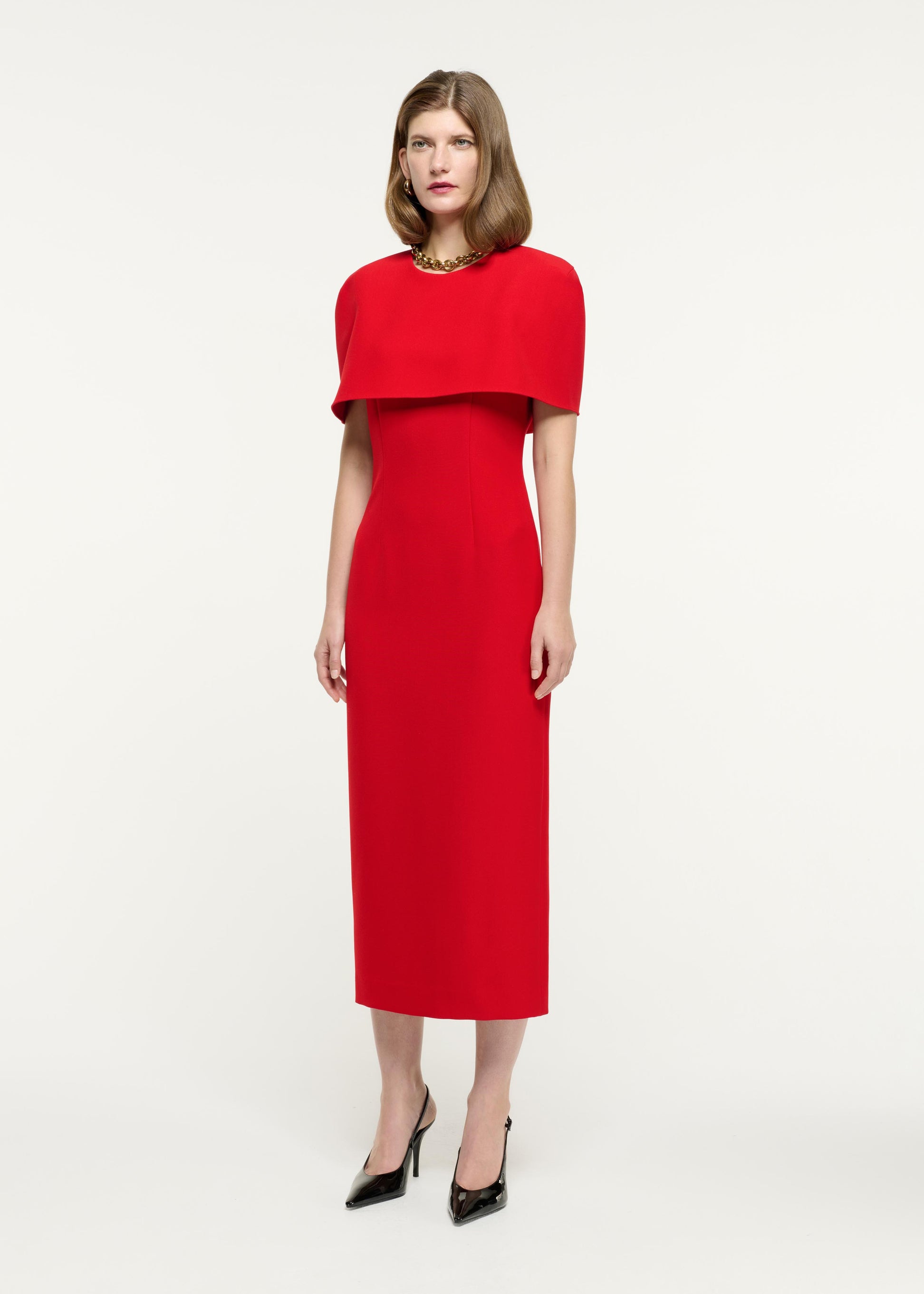 Side view of a model wearing the Cape Crepe Midi Dress in Red
