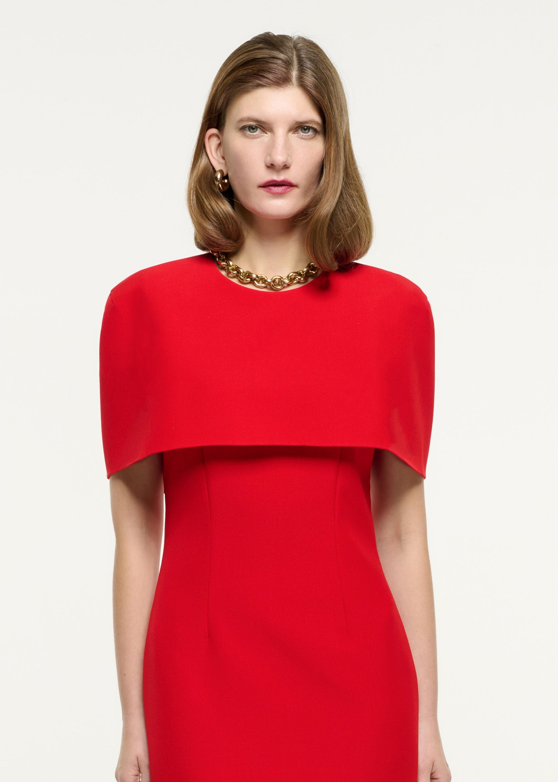Close up of a model wearing the Cape Crepe Midi Dress in Red