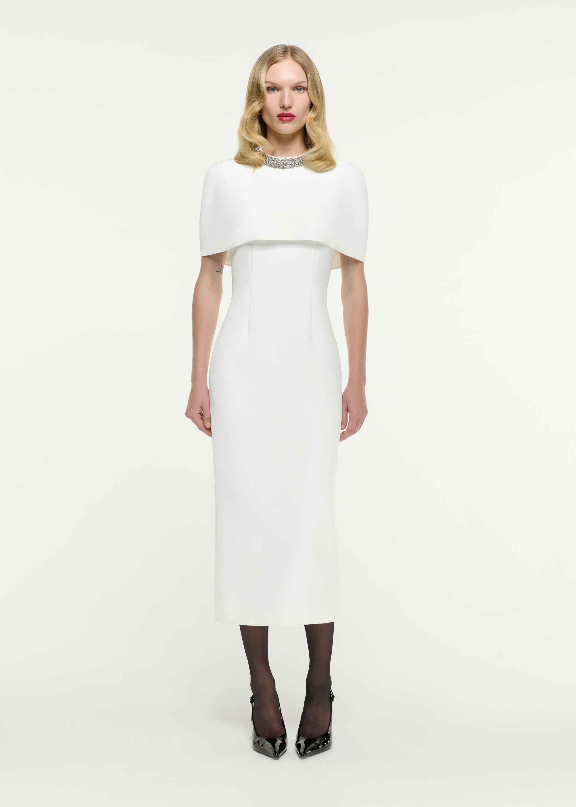 Front view of a model wearing the Cape Embellished Crepe Midi Dress in White