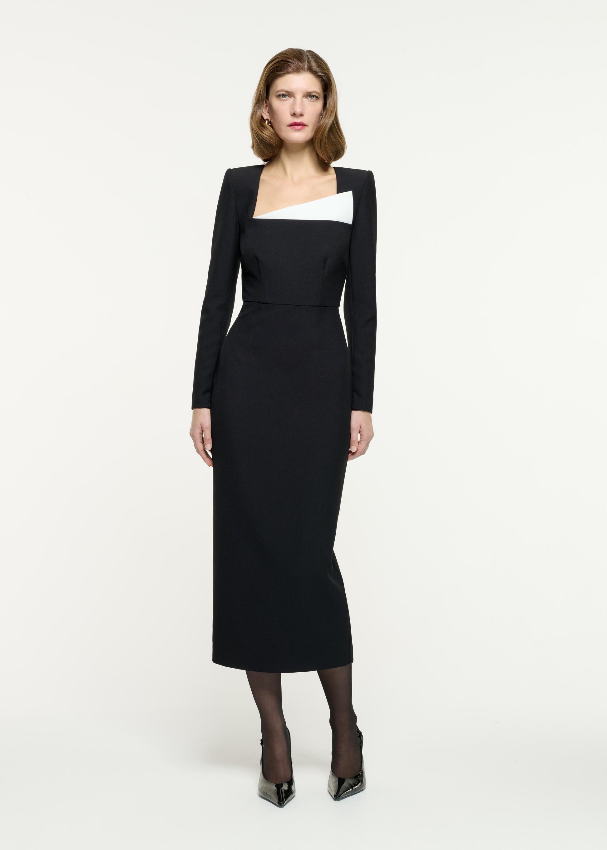 Front view of a model wearing the Contrast Panel Fitted Midi Dress in Monochrome