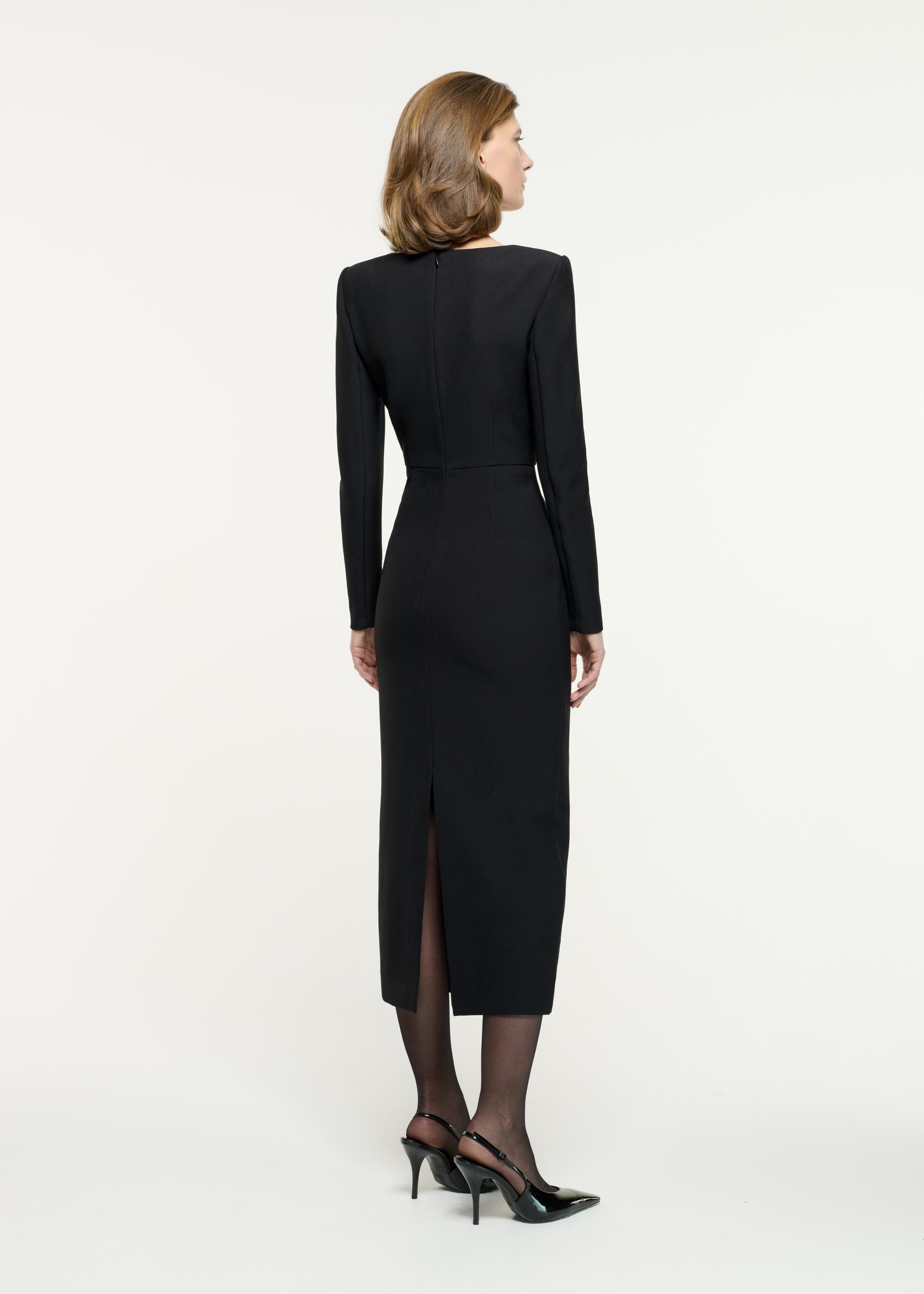 Back view of a model wearing the Contrast Panel Fitted Midi Dress in Monochrome