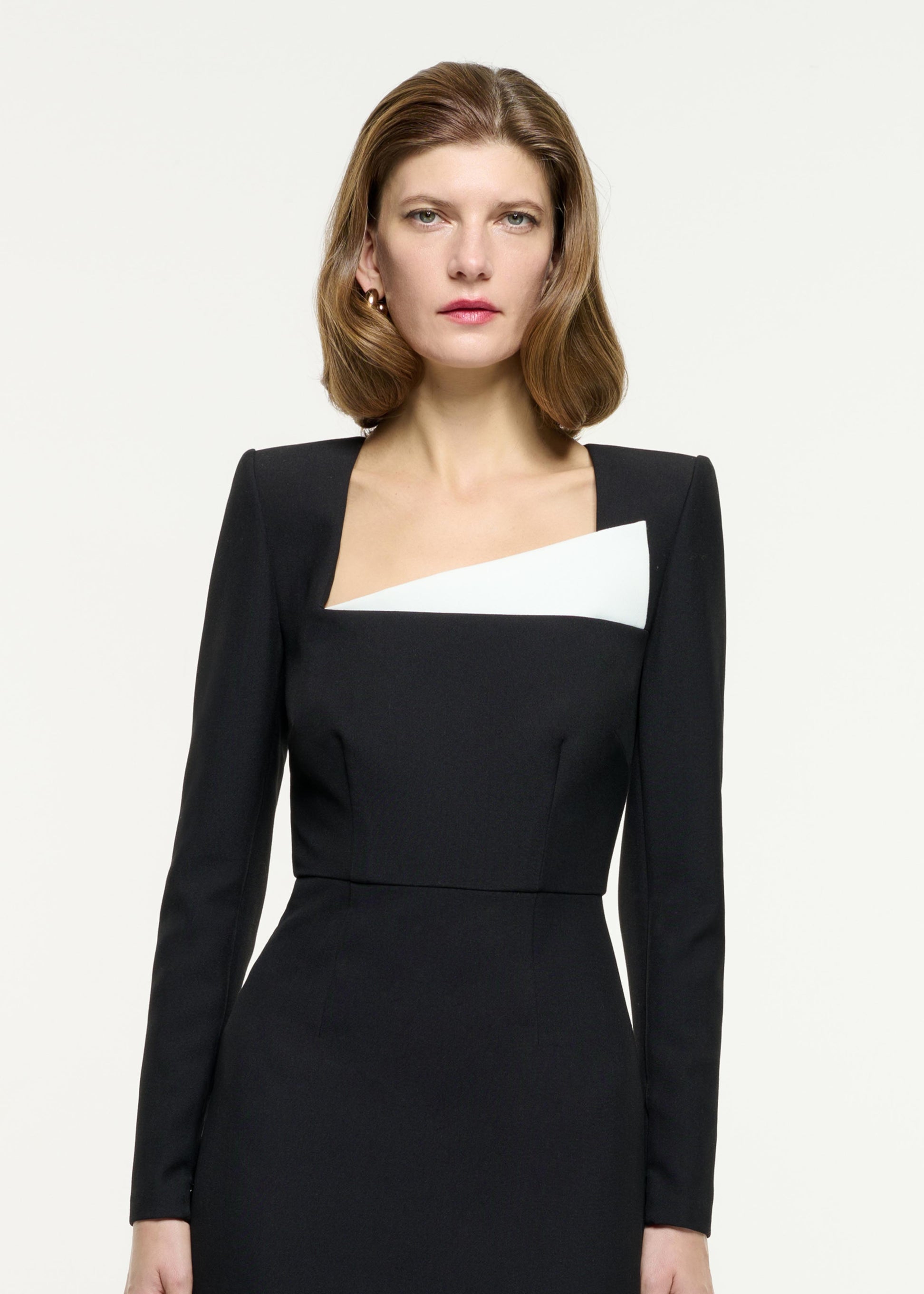 Close up of a model wearing the Contrast Panel Fitted Midi Dress in Monochrome